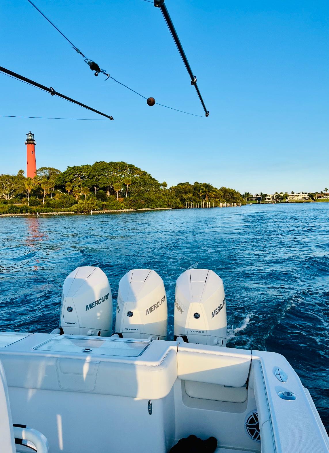 SeaVee-340Z 2024-REEL CRAFT FL-US-2024 SeaVee 340Z boat with triple Mercury engines near a lighthouse on a sunny day.-9768819 | Thumbnail