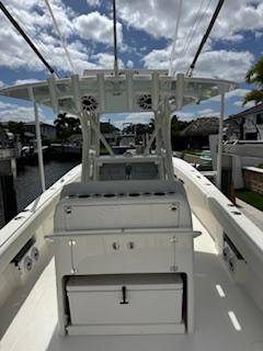 SeaVee-340Z 2024-REEL CRAFT FL-US-2024 SeaVee 340Z boat with center console and fishing rod holders, docked under a cloudy sky.-9768819 | Thumbnail