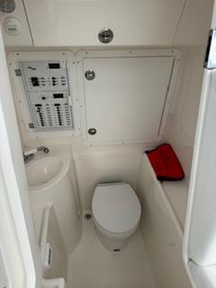 SeaVee-340Z 2024-REEL CRAFT FL-US-2024 SeaVee 340Z boat interior with toilet, sink, and control panel.-9768819 | Thumbnail