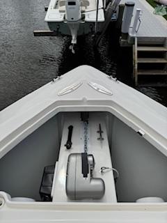 SeaVee-340Z 2024-REEL CRAFT FL-US-2024 SeaVee 340Z boat bow with anchor storage, docked near wooden pier.-9768819 | Thumbnail