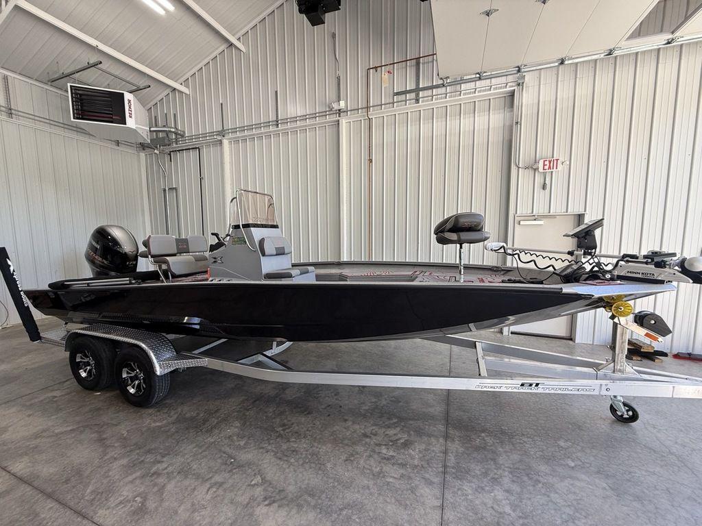 2024 Xpress H22B boat on trailer in a garage setting.