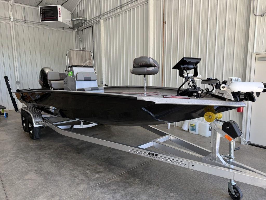 2024 Xpress H22B boat in a garage, featuring modern seating and equipment.