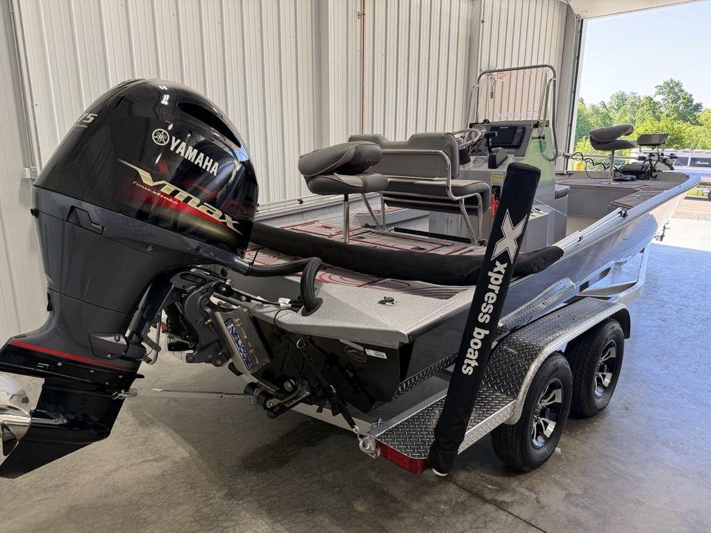 2024 Xpress H22B boat with Yamaha engine in a garage setting.