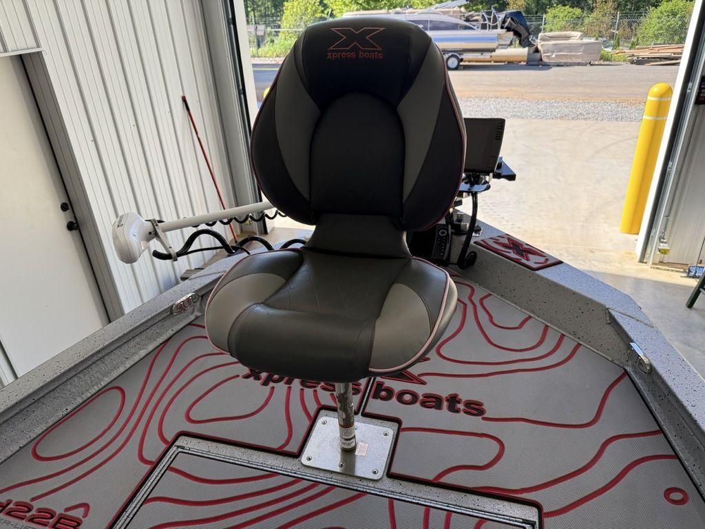 2024 Xpress H22B boat seat with modern design in a showroom setting.