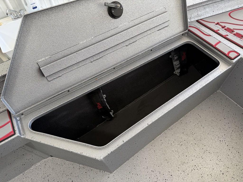 Open storage compartment in 2024 Xpress H22B boat, showcasing spacious interior design.