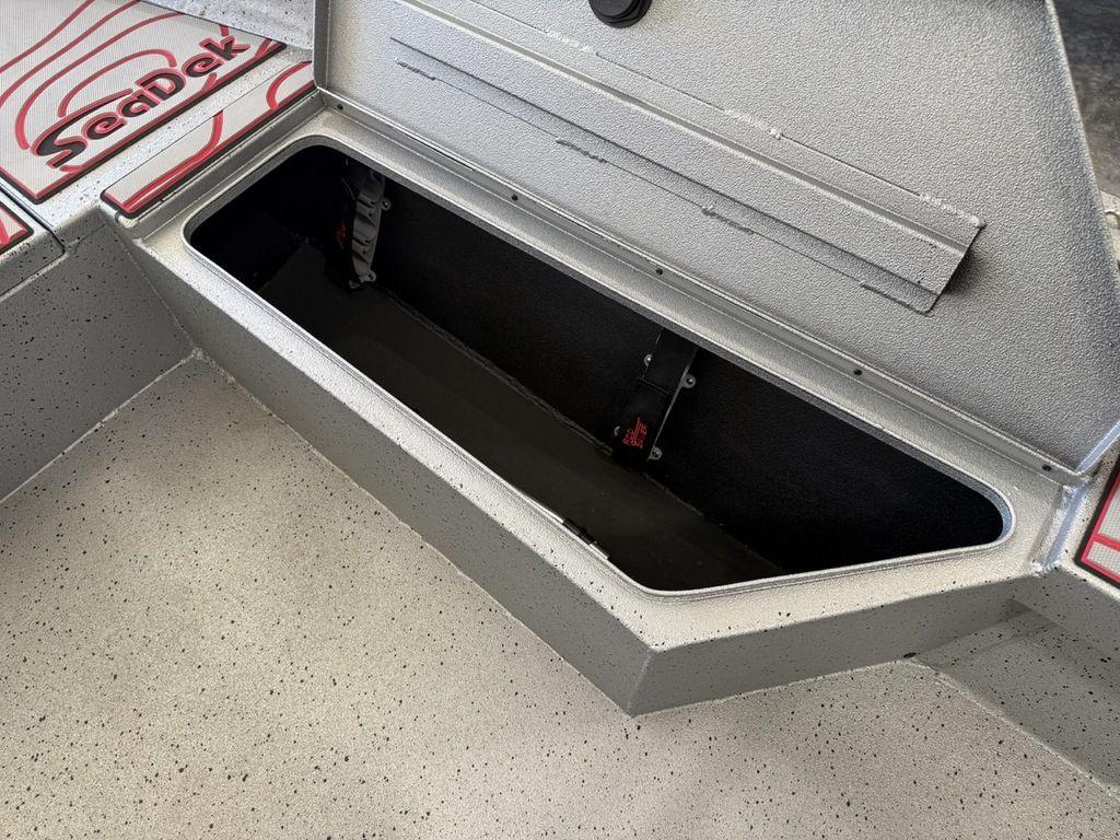 Open storage compartment in 2024 Xpress H22B boat with SeaDek flooring.