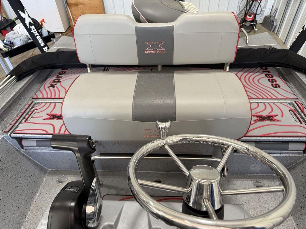 2024 Xpress H22B boat interior with steering wheel and seating.