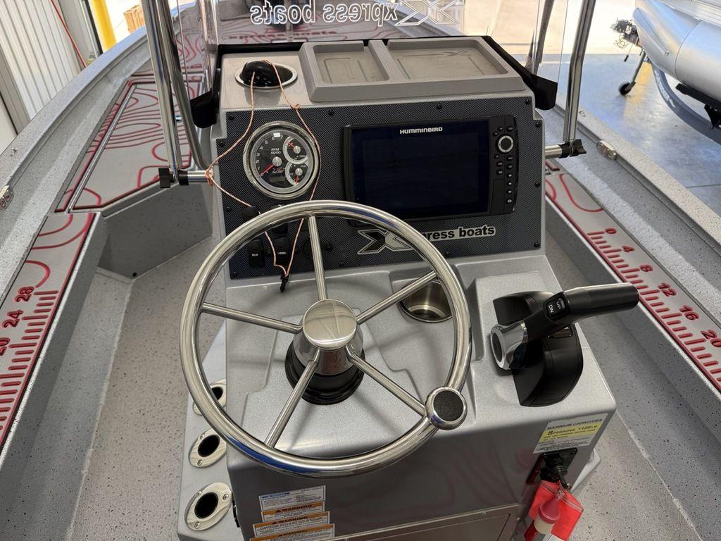 2024 Xpress H22B boat console with steering wheel and navigation system.