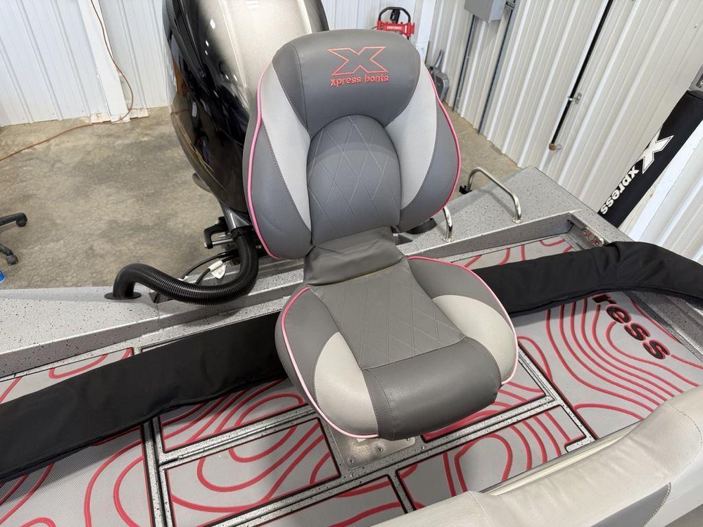 2024 Xpress H22B boat seat with gray and pink design in a garage setting.