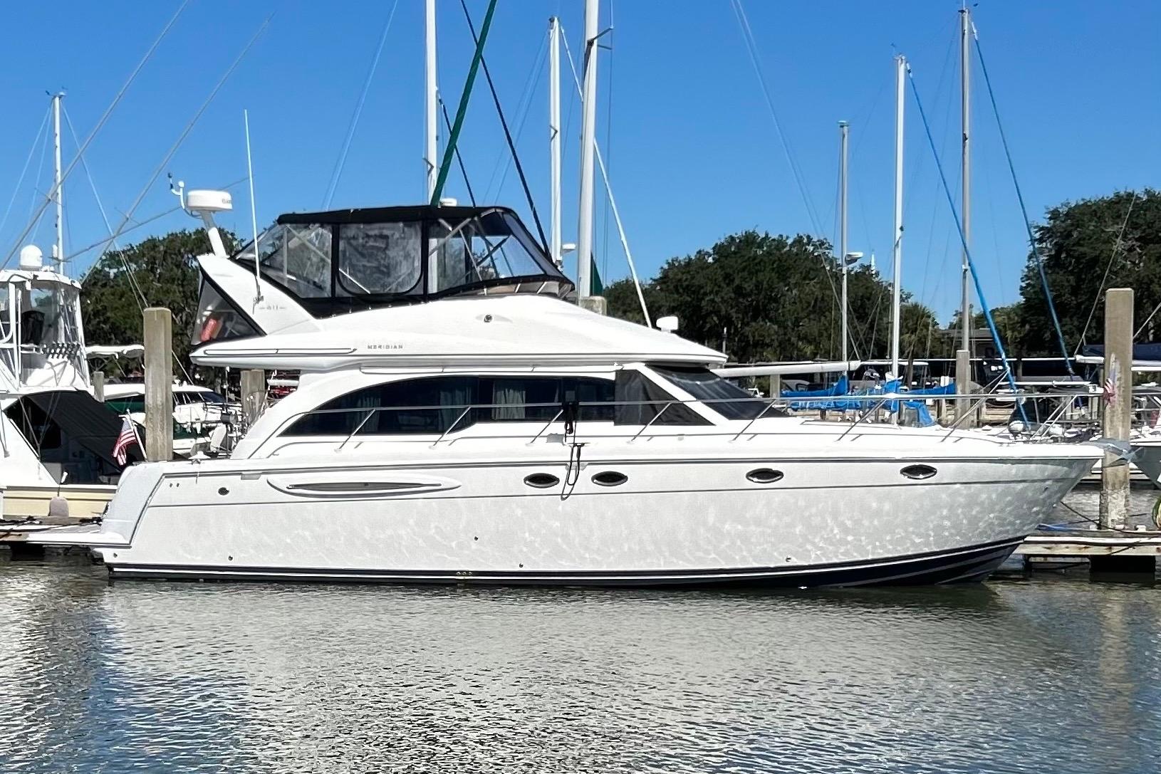 2007 Meridian 411SB yacht docked at marina, clear sky, calm water.