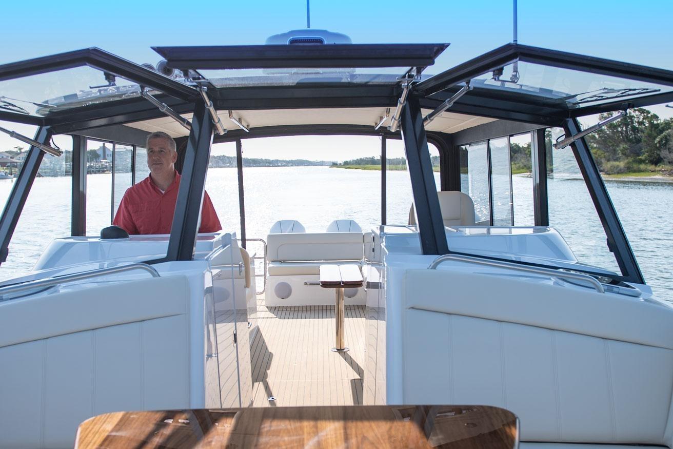 2025 MJM 3 boat interior with open cockpit and scenic water view.
