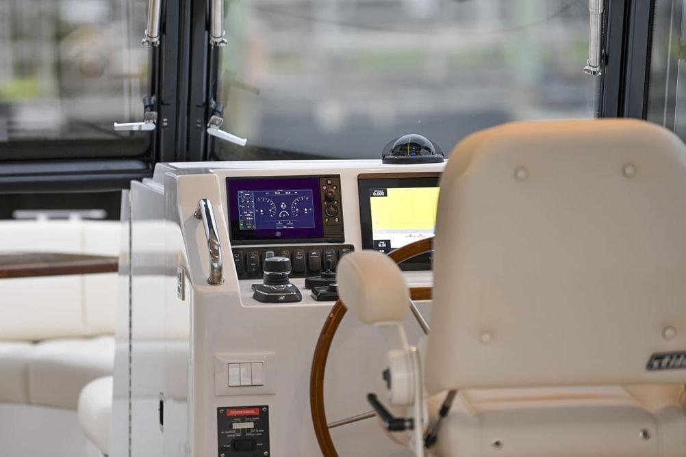 Helm of 2025 MJM 3 boat with modern navigation controls and steering wheel.