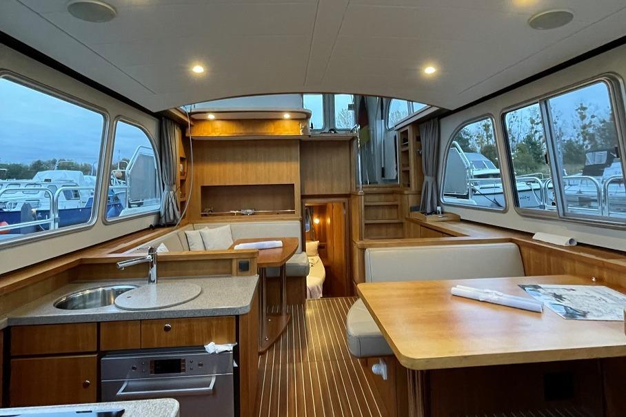 Interior of 2016 Linssen Grand Sturdy 410 AC Variotop yacht, featuring wood finishes and modern amenities.