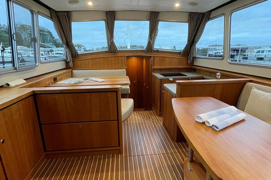 Interior of 2016 Linssen Grand Sturdy 410 AC Variotop yacht, featuring elegant wood finishes.