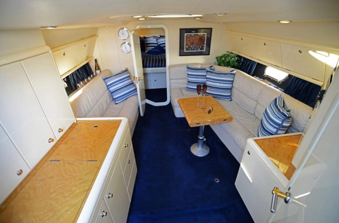 Interior of 1994 Sunseeker Apache 45 yacht with blue carpet and beige seating.