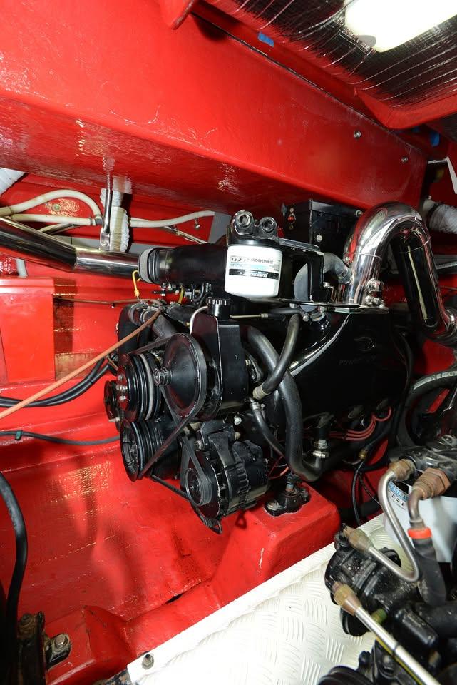 Engine compartment of a 1994 Sunseeker Apache 45, showcasing mechanical components and red interior.