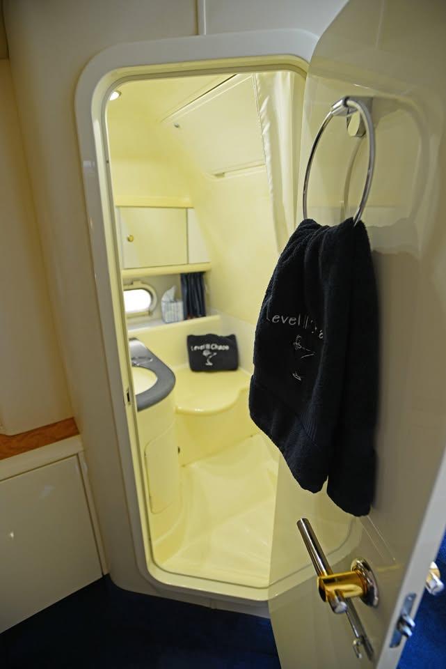 Interior view of 1994 Sunseeker Apache 45 yacht bathroom with towel on door.