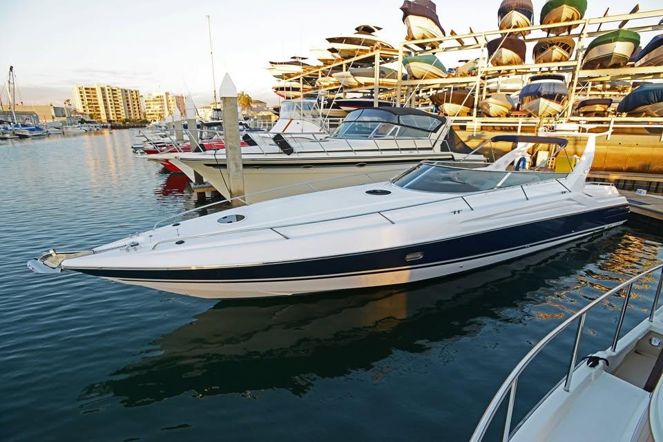 1994 Sunseeker Apache 45 yacht docked in a marina at sunset.