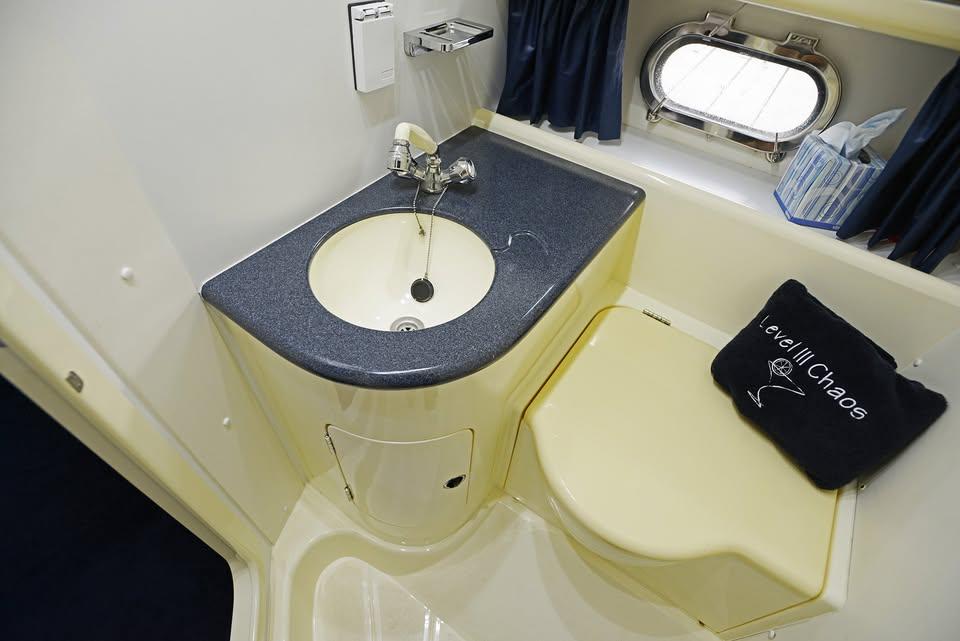Bathroom interior of 1994 Sunseeker Apache 45 yacht with sink and porthole.