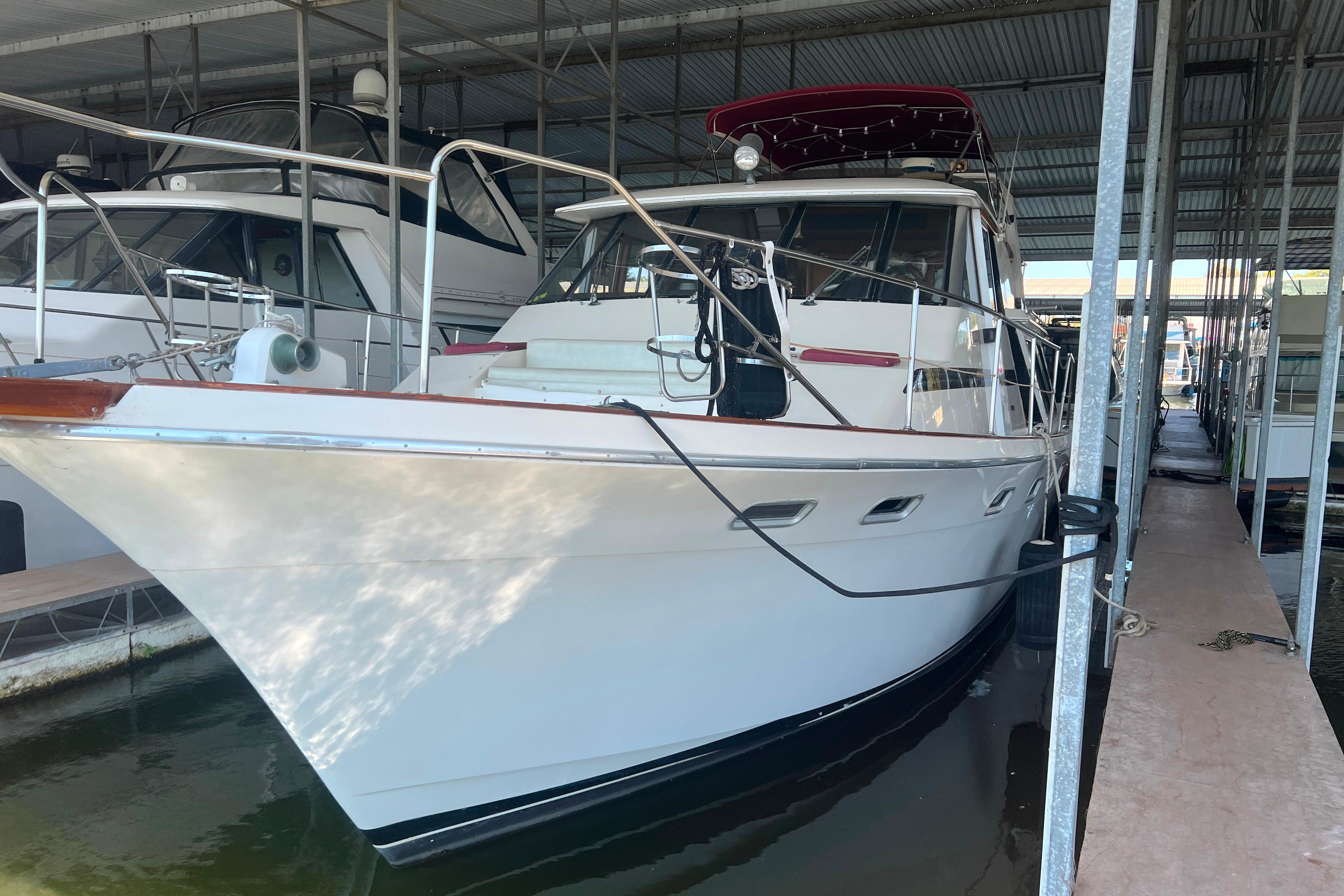 1986 Bayliner 4550 Motoryacht docked in a covered marina.