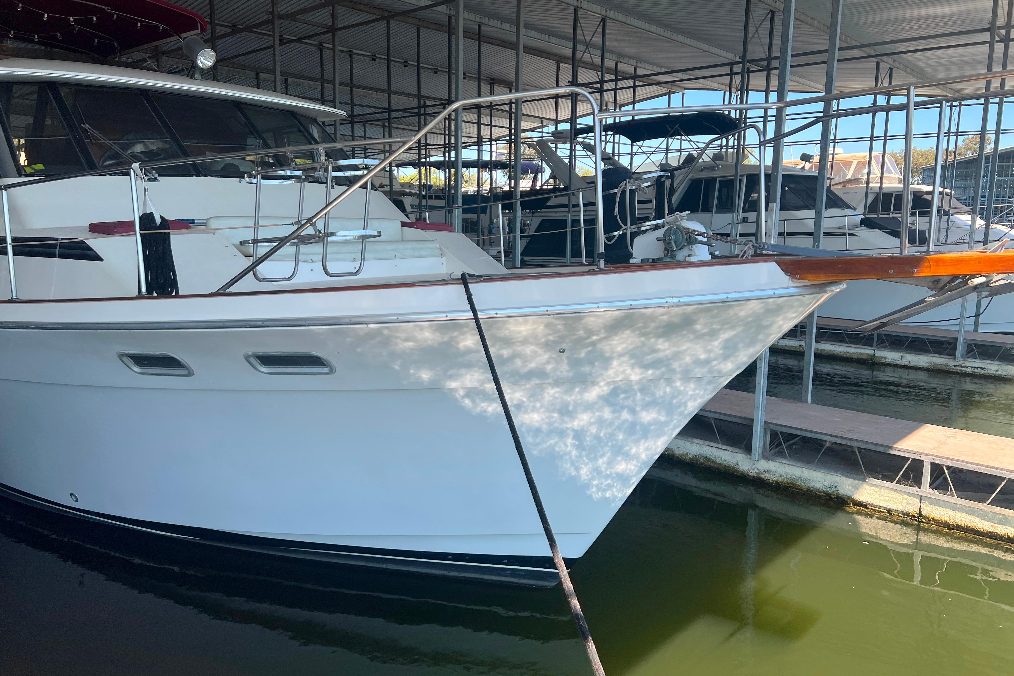 1986 Bayliner 4550 Motoryacht docked in a marina, side view.