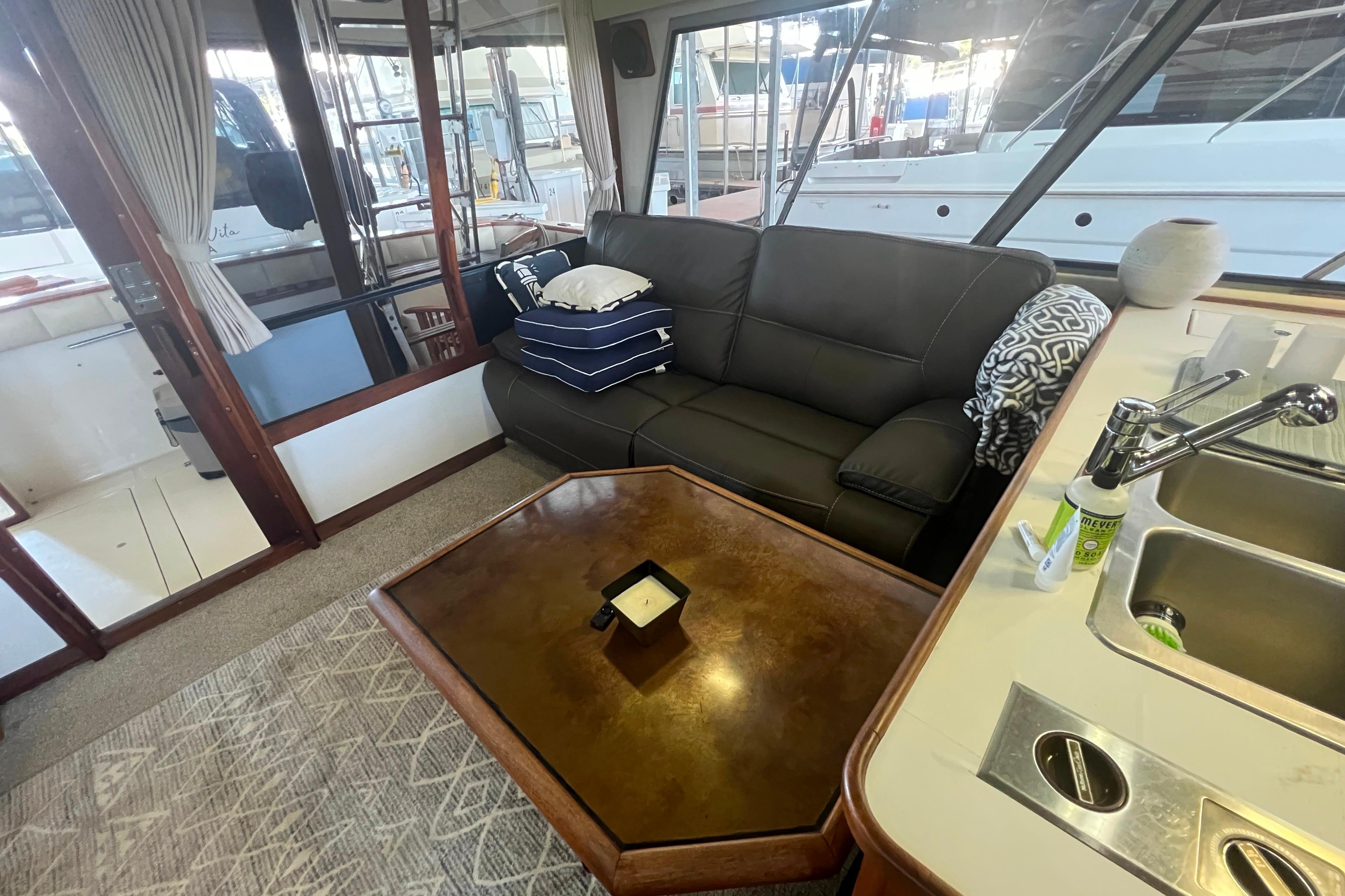 Interior of 1986 Bayliner 4550 Motoryacht with sofa, table, and kitchenette.