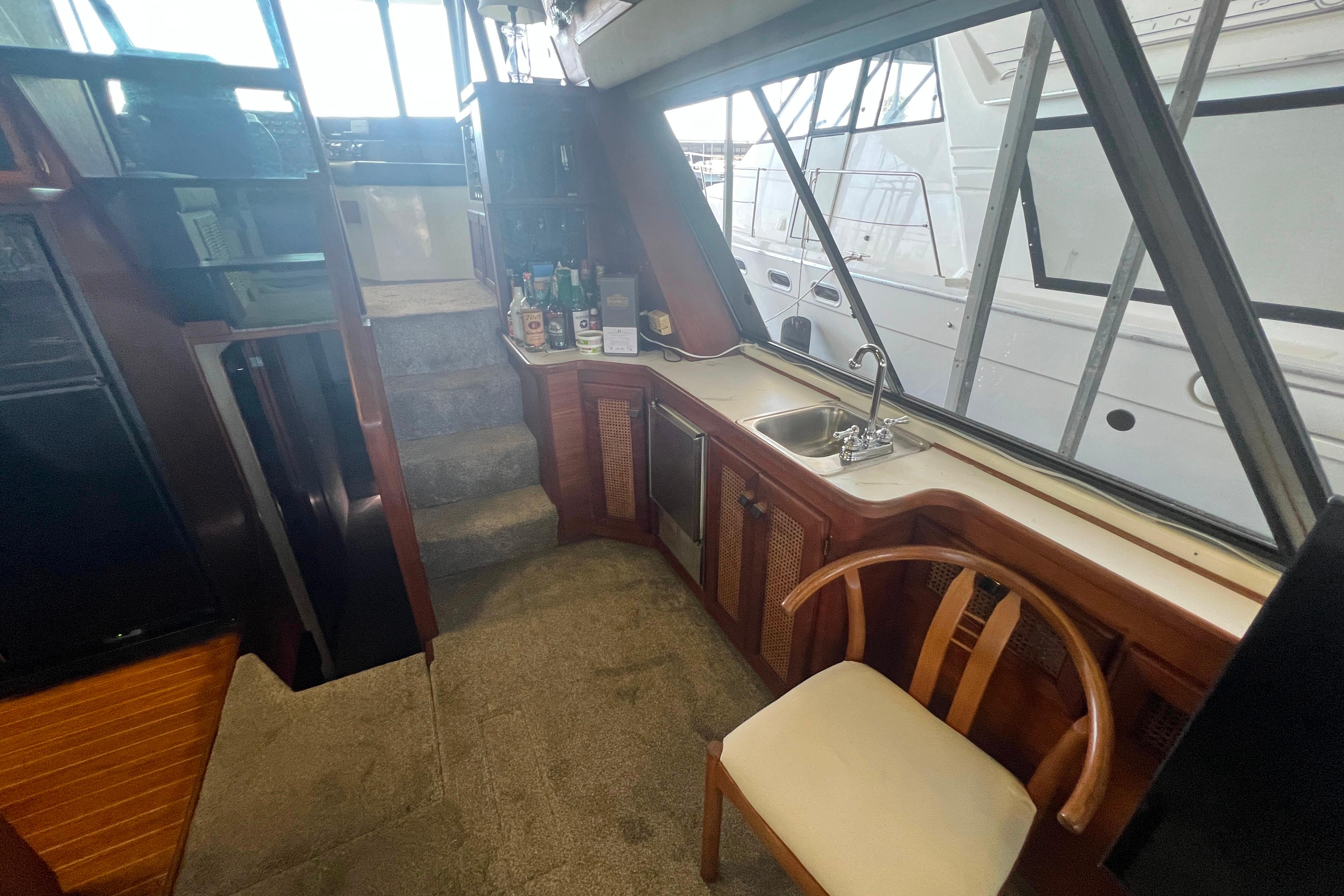 Interior of 1986 Bayliner 4550 Motoryacht with kitchenette and seating area.