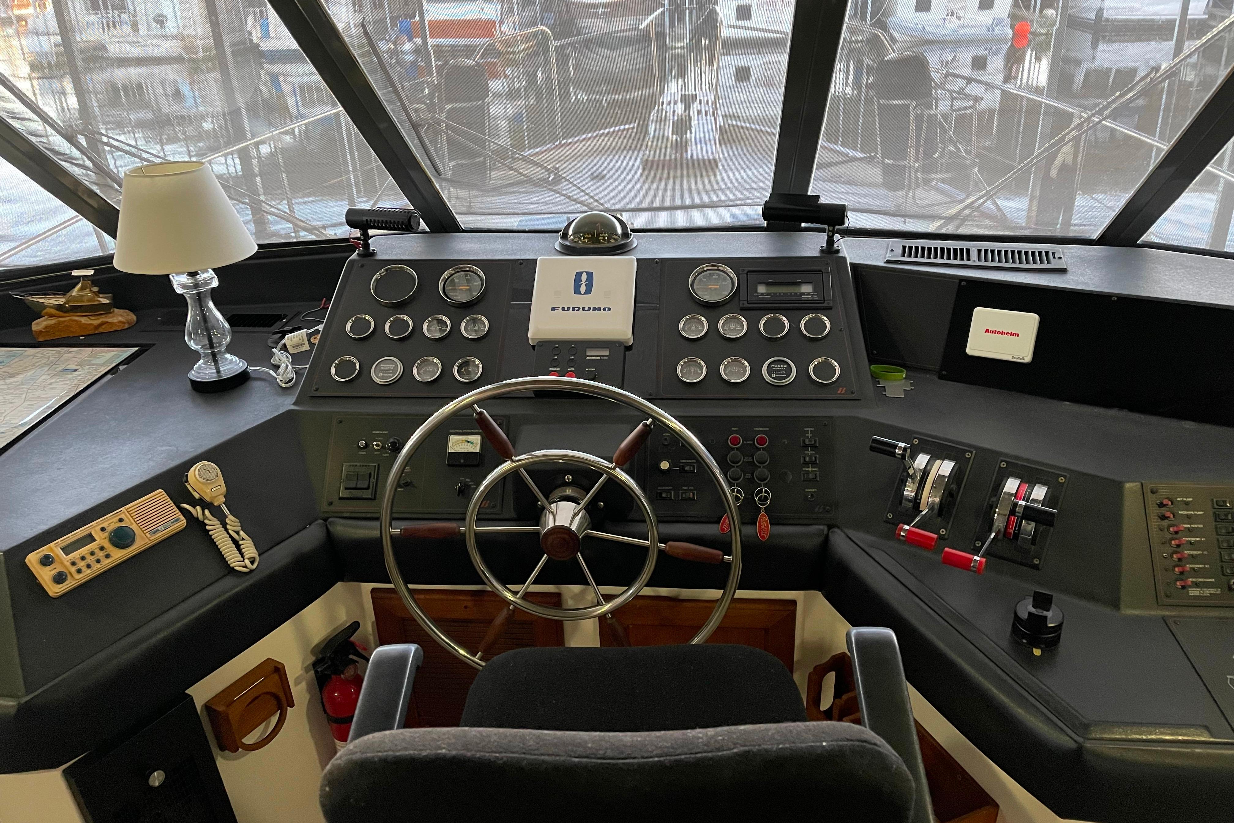 Cockpit of 1986 Bayliner 4550 Motoryacht with steering wheel and navigation instruments.
