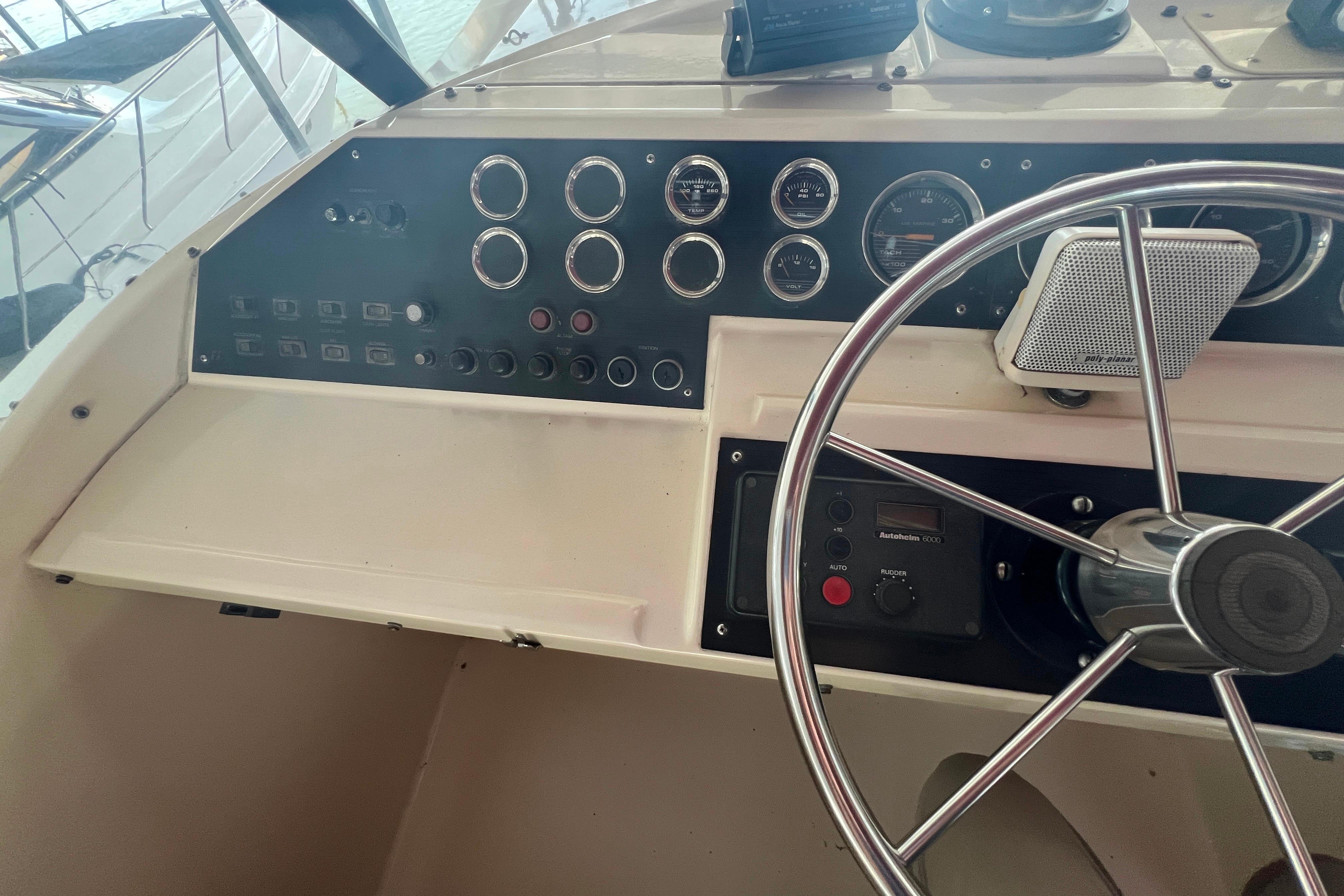 Control panel of 1986 Bayliner 4550 Motoryacht with steering wheel and gauges.