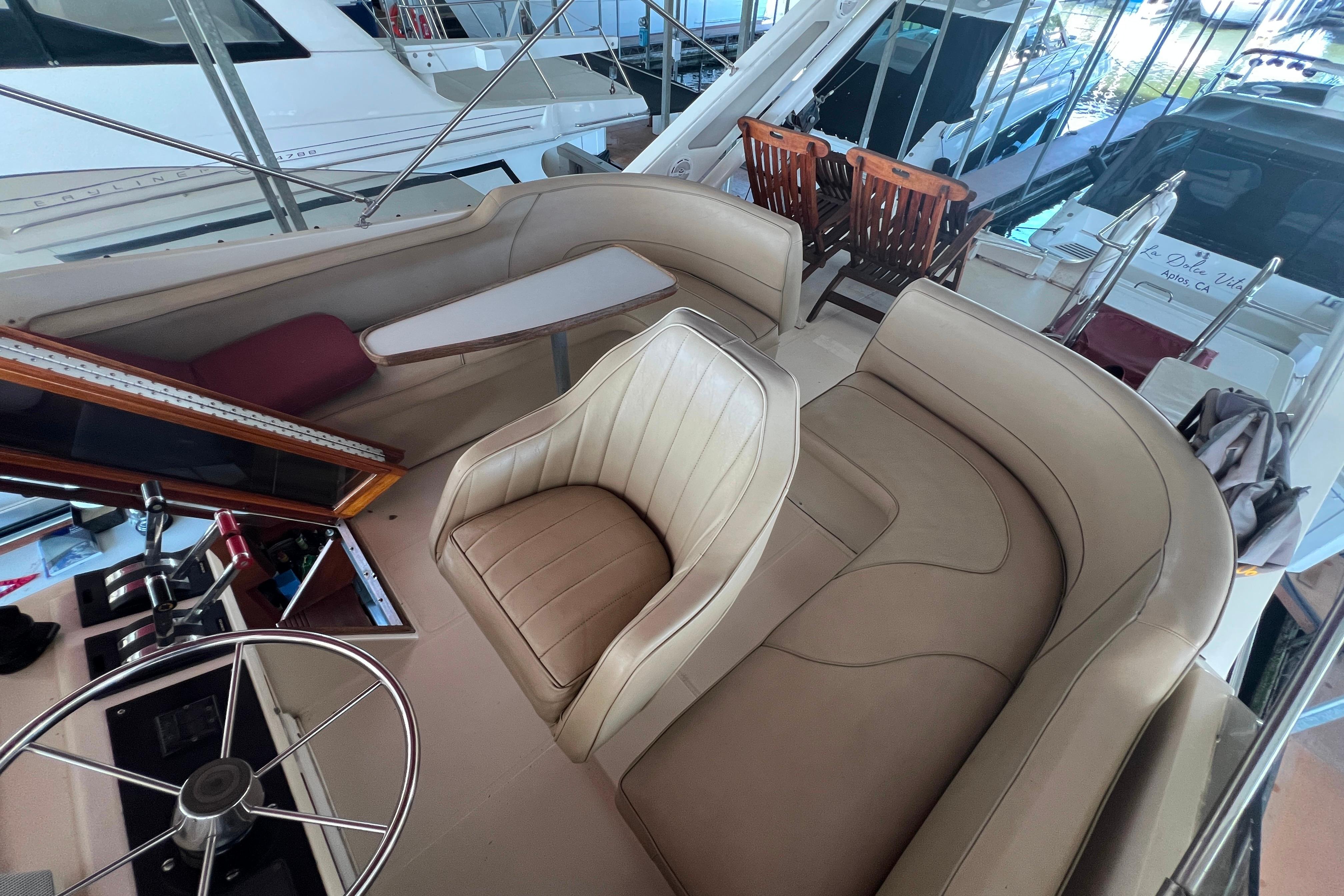 1986 Bayliner 4550 Motoryacht interior with beige seating and steering wheel.