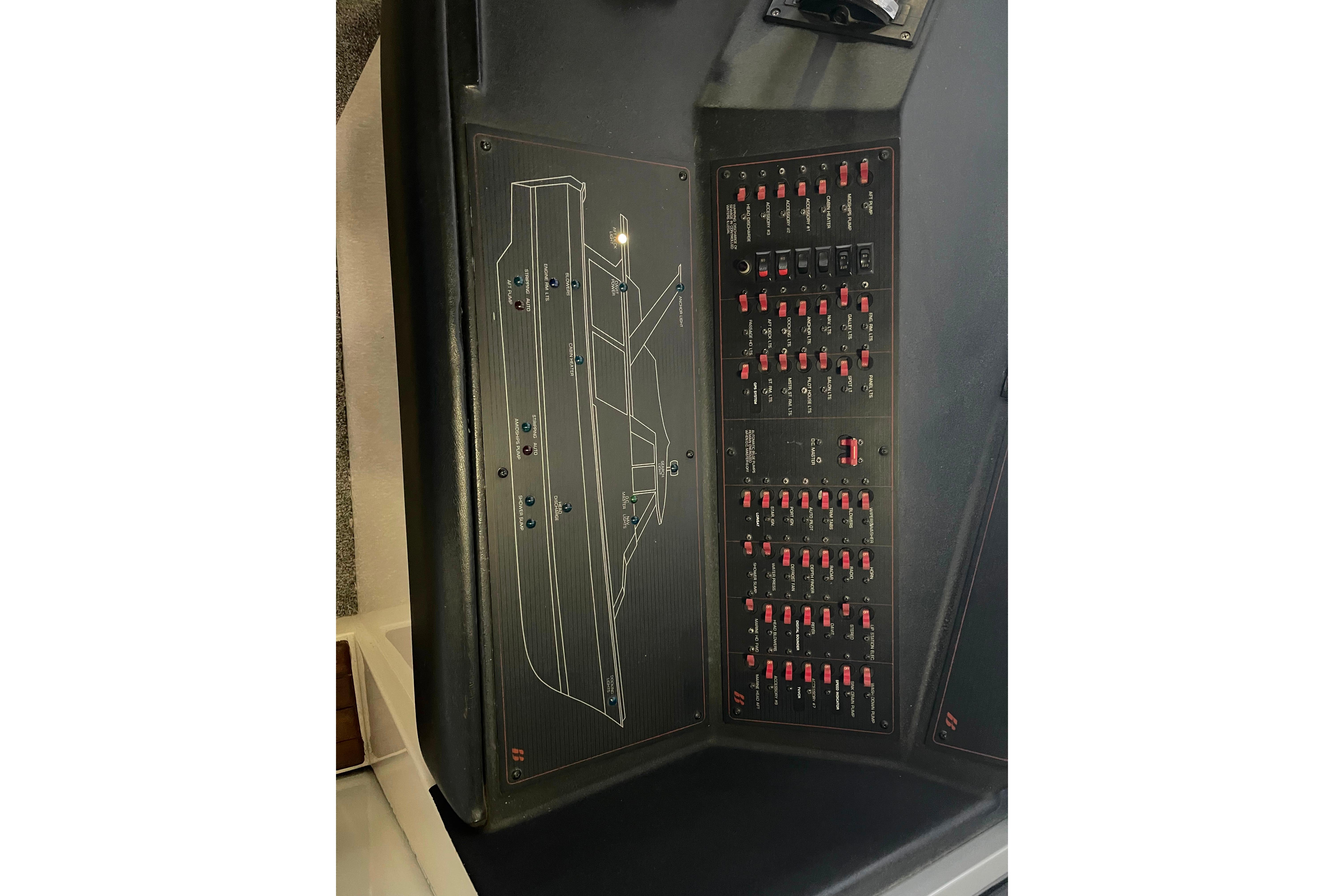 Control panel of a 1986 Bayliner 4550 Motoryacht with switches and diagram.
