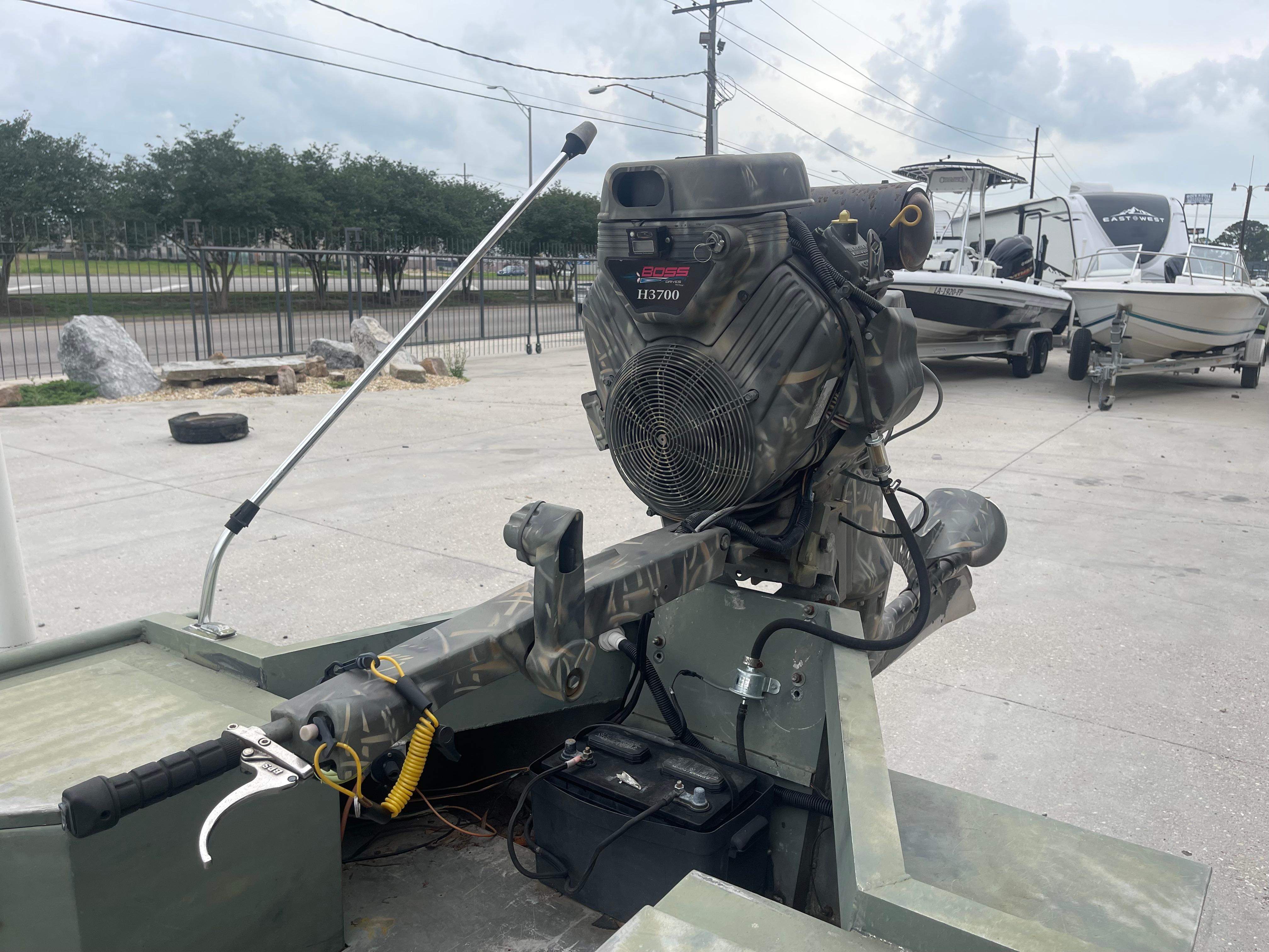 2016 WeldBilt 18x48 boat with motor, parked on concrete lot.