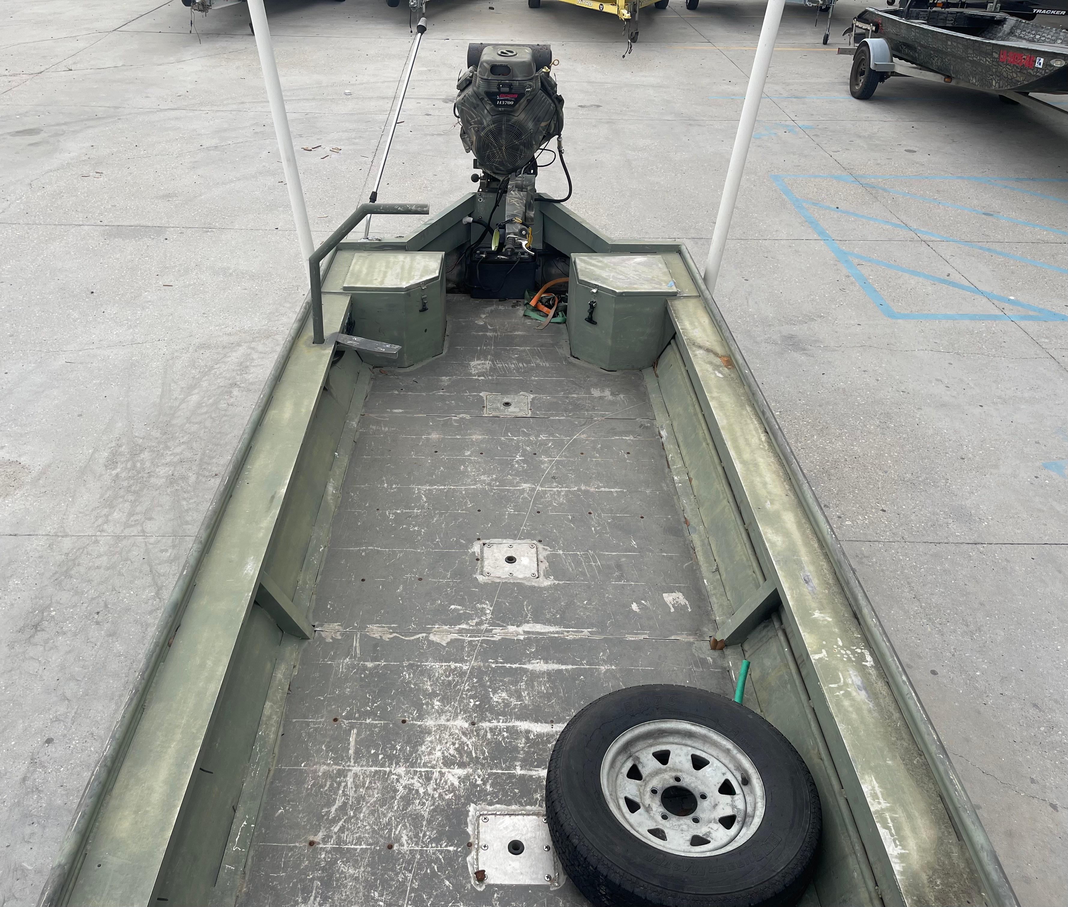 2016 WeldBilt 18x48 aluminum boat with outboard motor and spare tire.