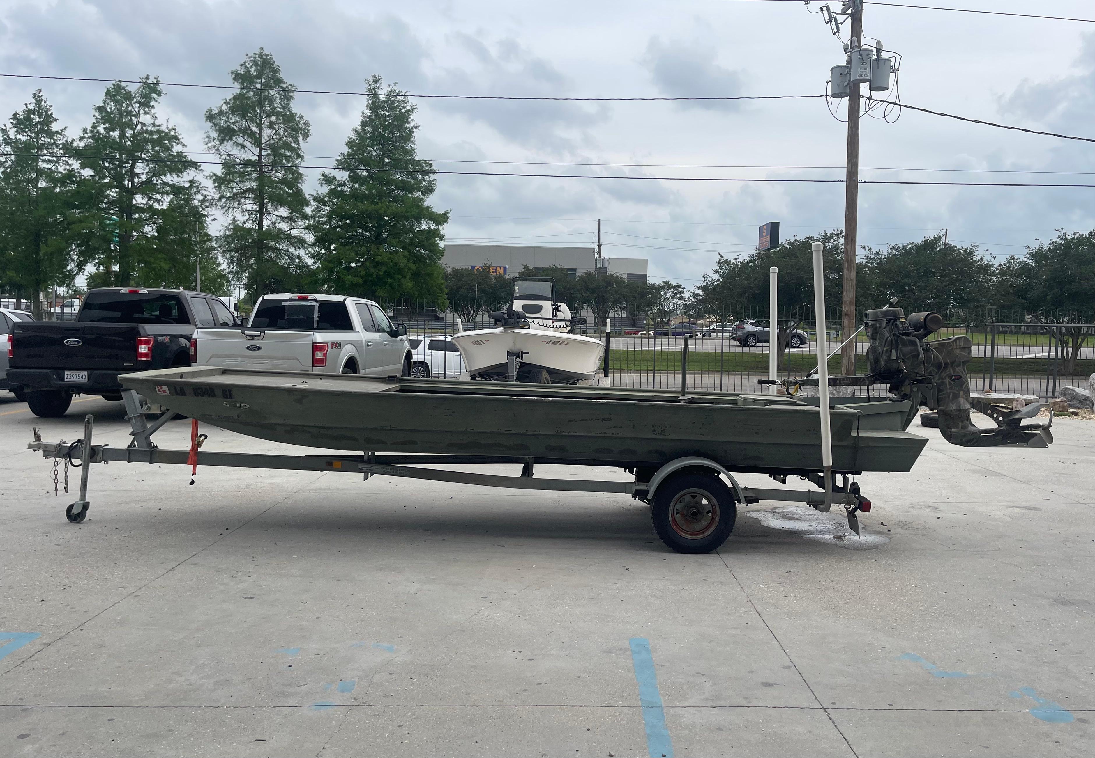 2016 WeldBilt 18x48 boat on trailer in parking lot.