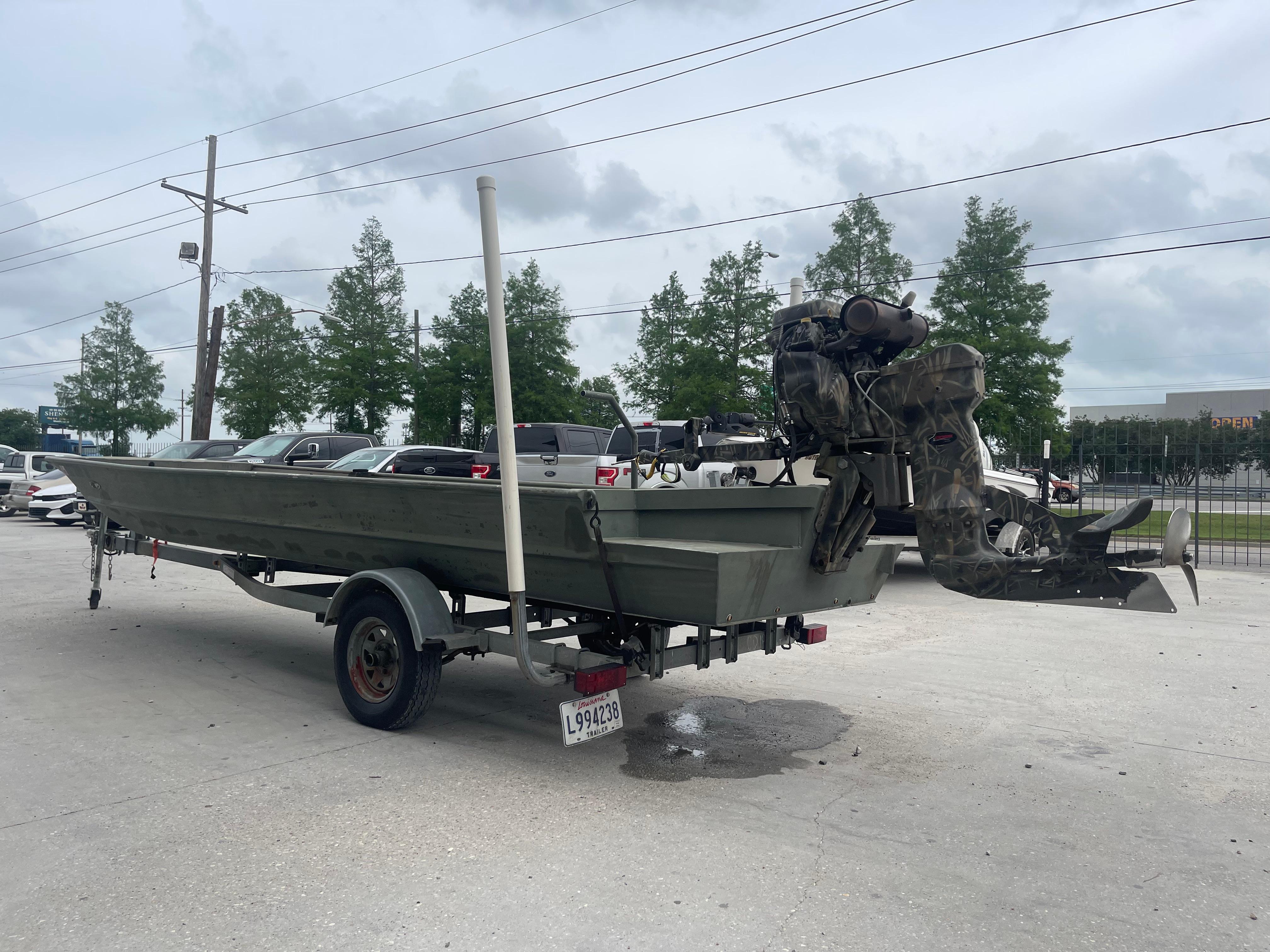 2016 WeldBilt 18x48 boat on trailer with outboard motor in parking lot.