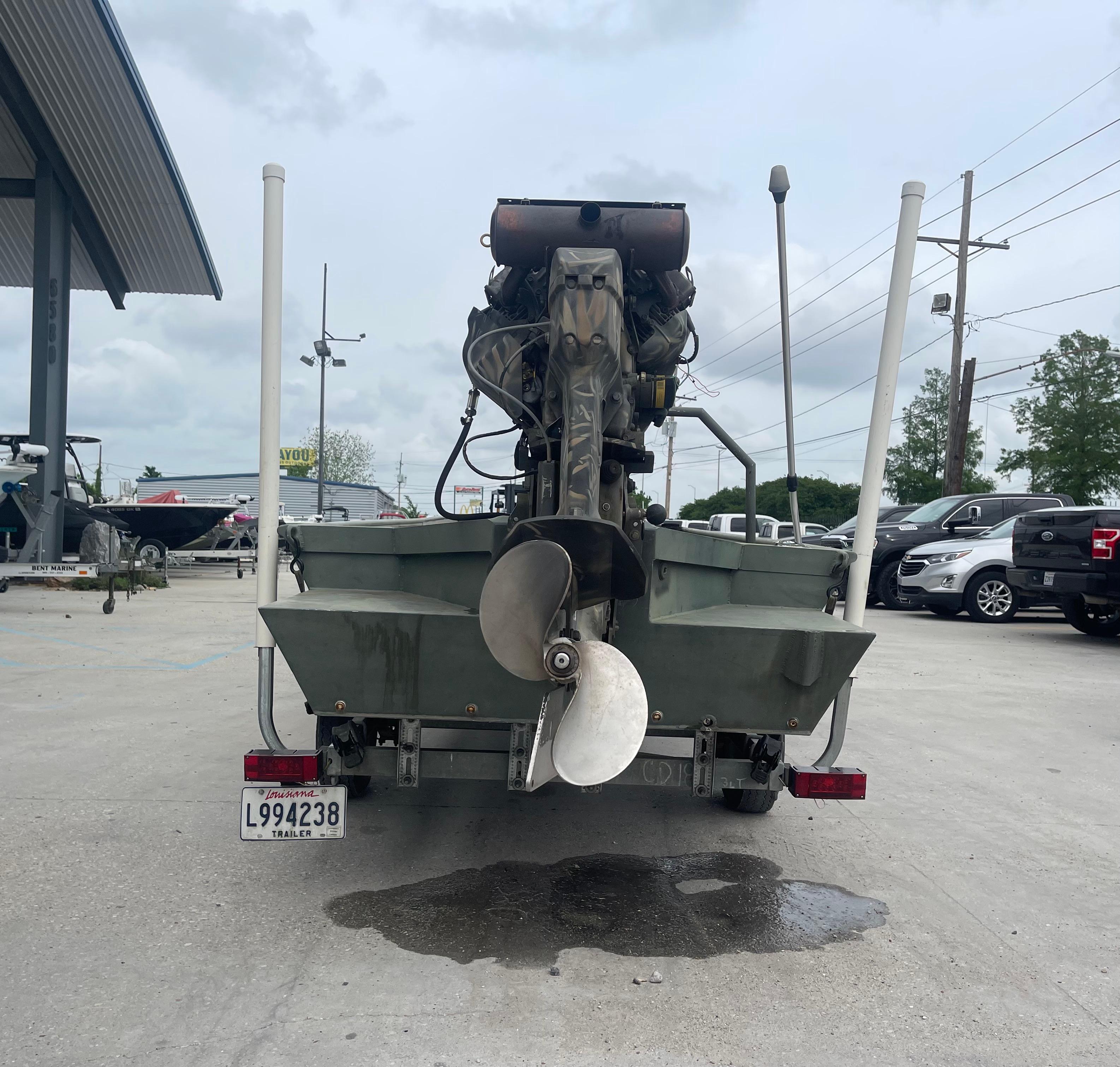Rear view of a 2016 WeldBilt 18x48 boat with an outboard motor.