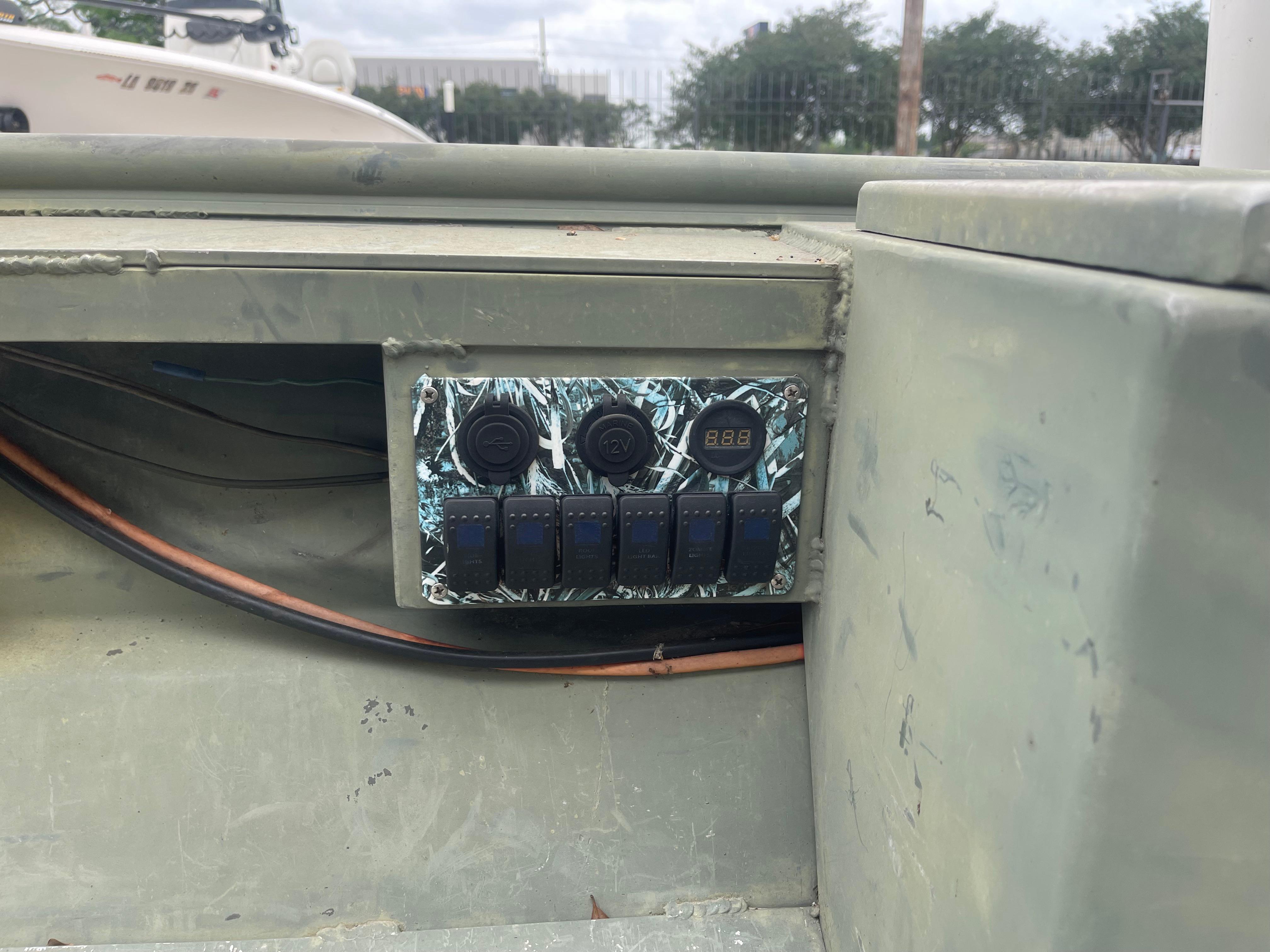 Control panel on a 2016 WeldBilt 18x48 boat with switches and voltage display.