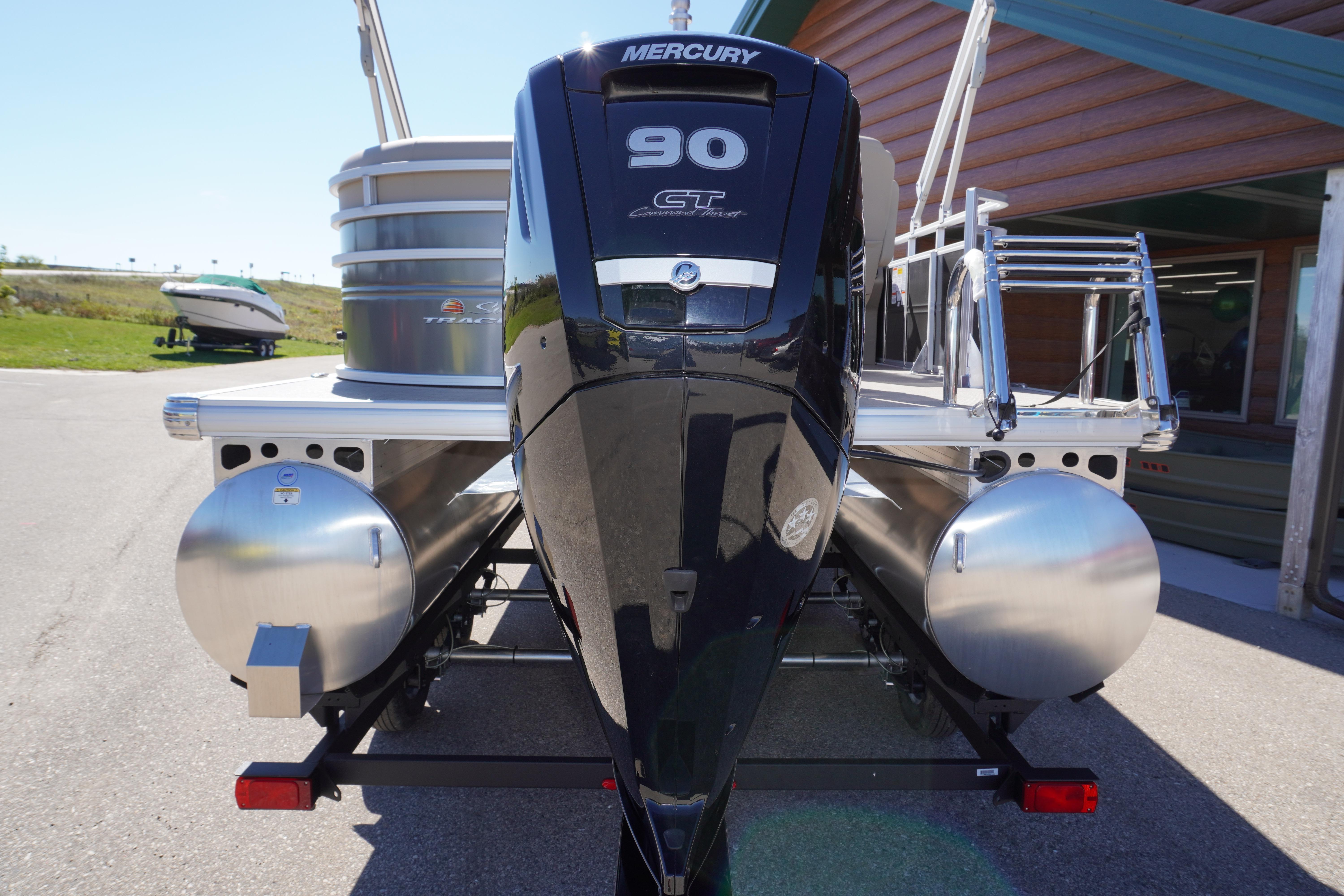 2024 Sun Tracker Party Barge 20 DLX with Mercury 90 engine, parked outdoors.