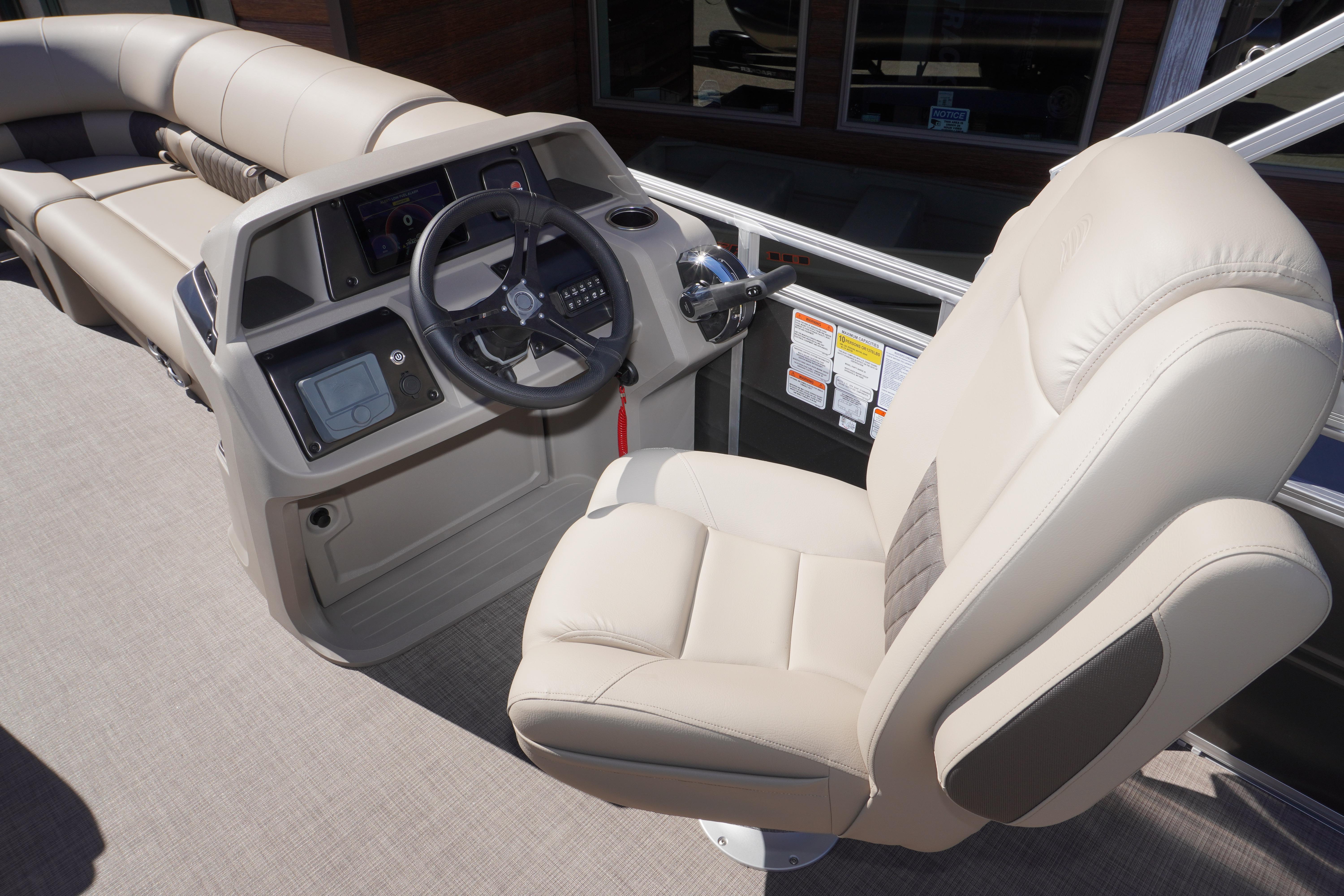 2024 Sun Tracker Party Barge 20 DLX helm with plush captain's chair and modern controls.
