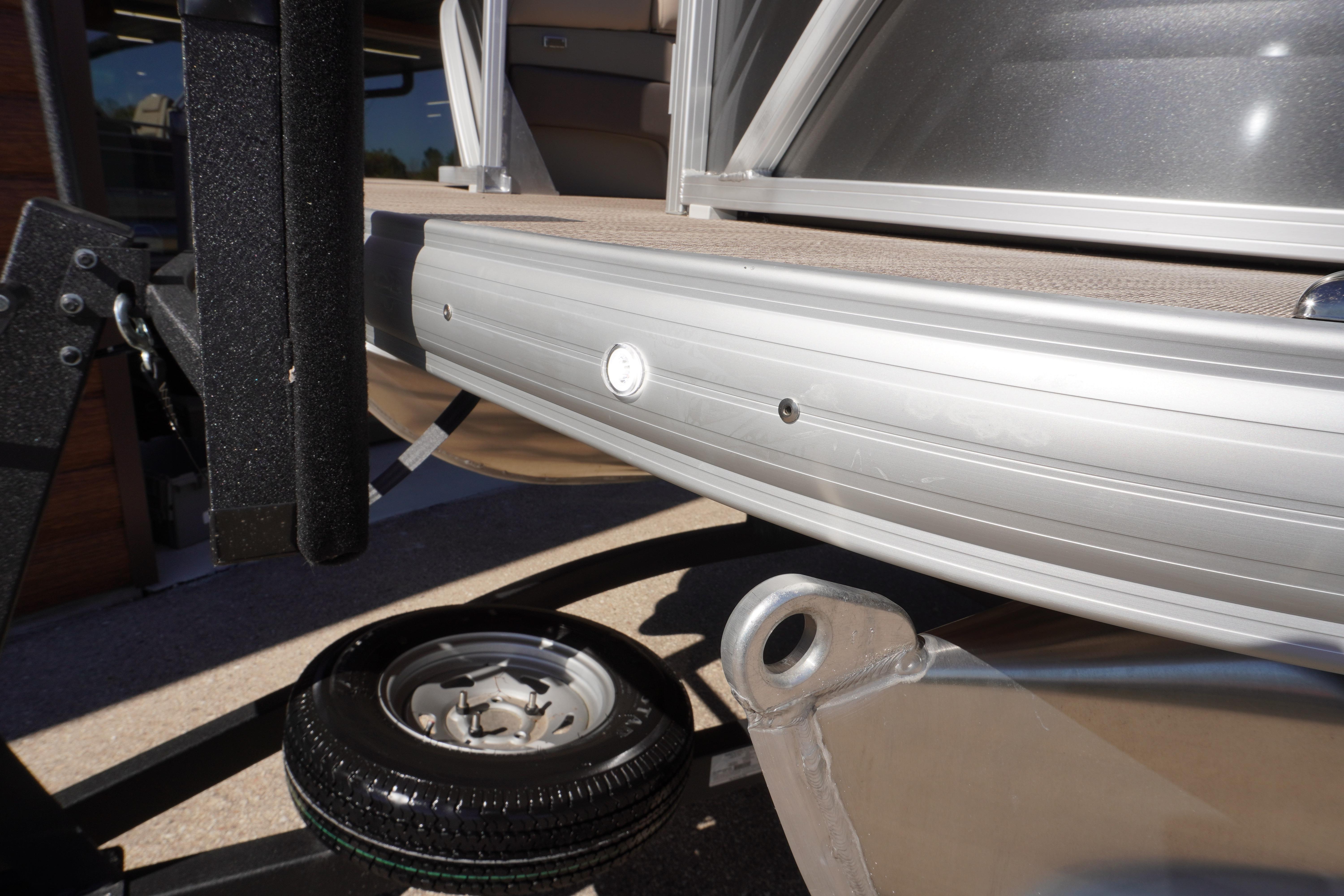 2024 Sun Tracker Party Barge 20 DLX pontoon boat detail with trailer wheel.
