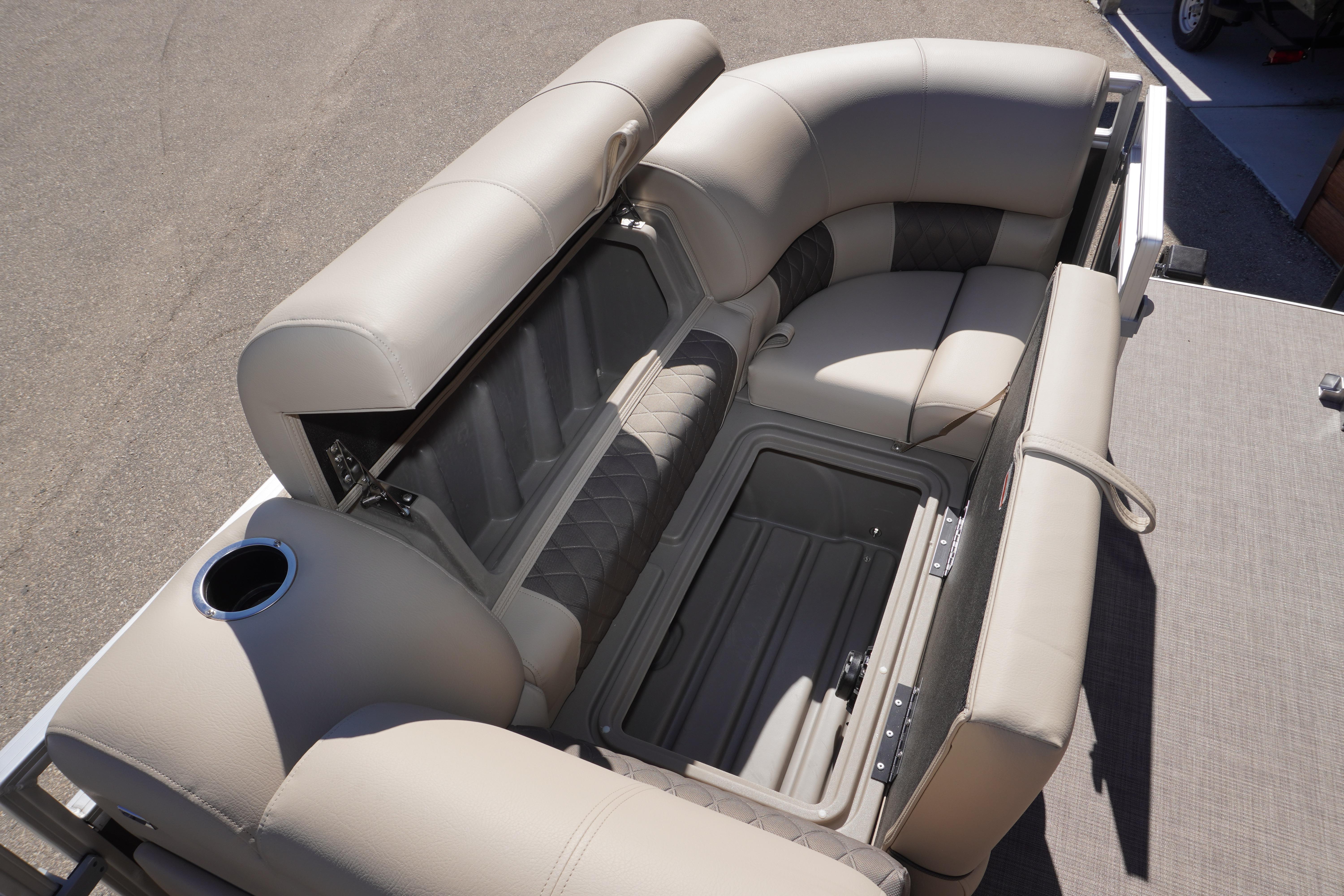 2024 Sun Tracker Party Barge 20 DLX seating with storage compartment open.