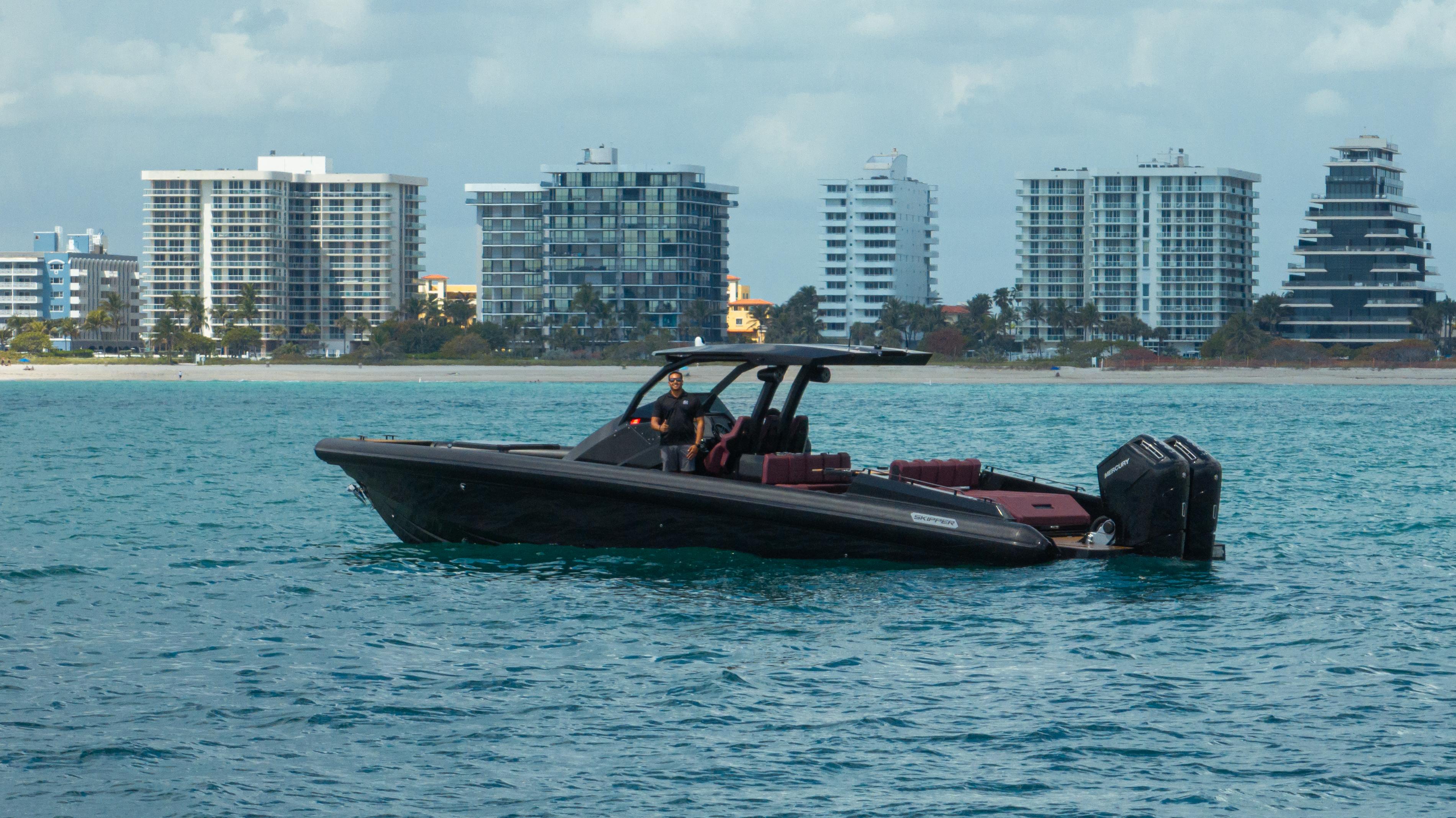 Skipper-BSK-42NC 2023 -FL-US-2023 Skipper-BSK 42NC boat on water with city skyline in background.-9768987 | Thumbnail