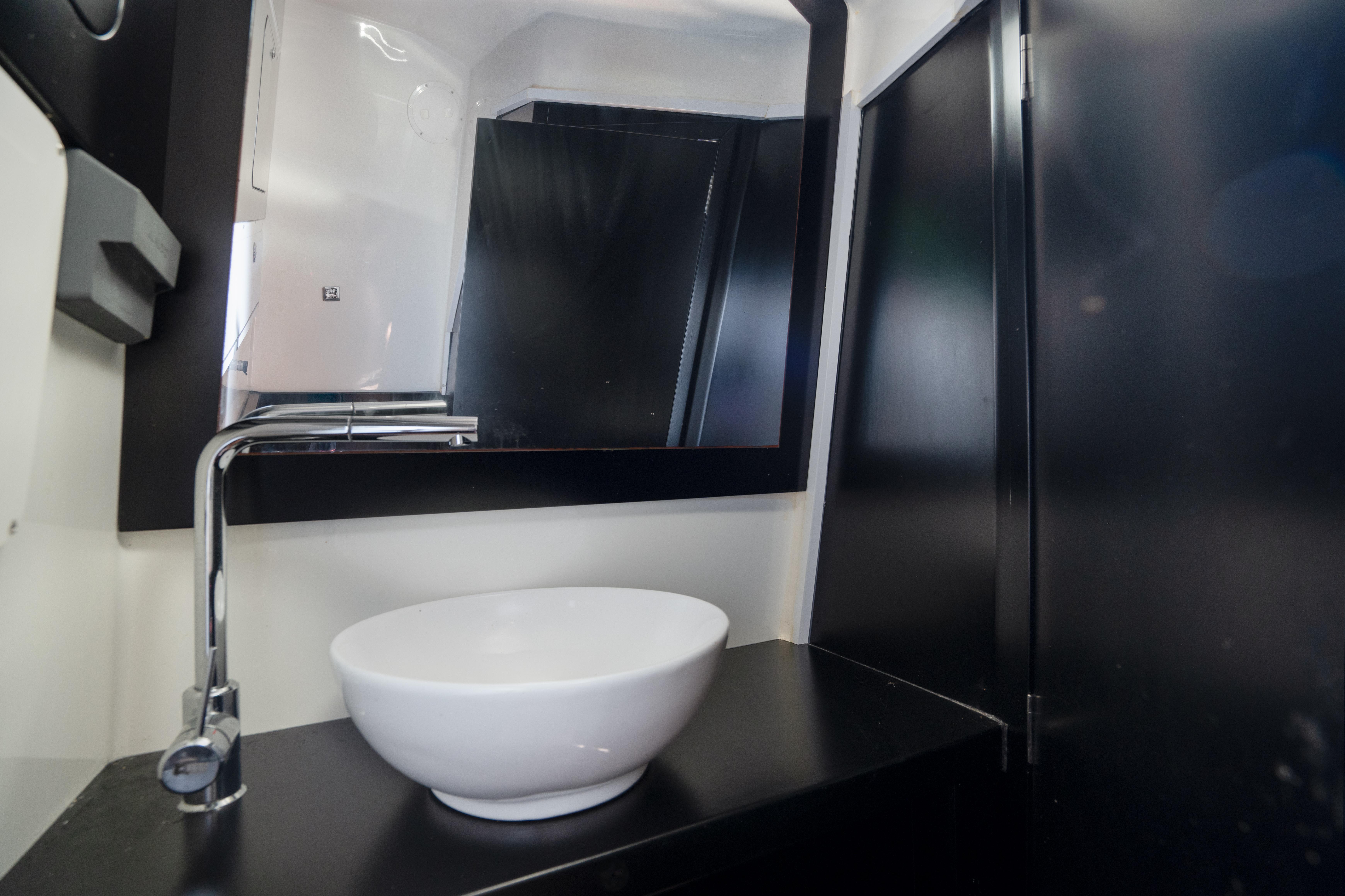 Skipper-BSK-42NC 2023 -FL-US-Modern bathroom interior in 2023 Skipper-BSK 42NC yacht with sleek sink and mirror.-9768987 | Thumbnail