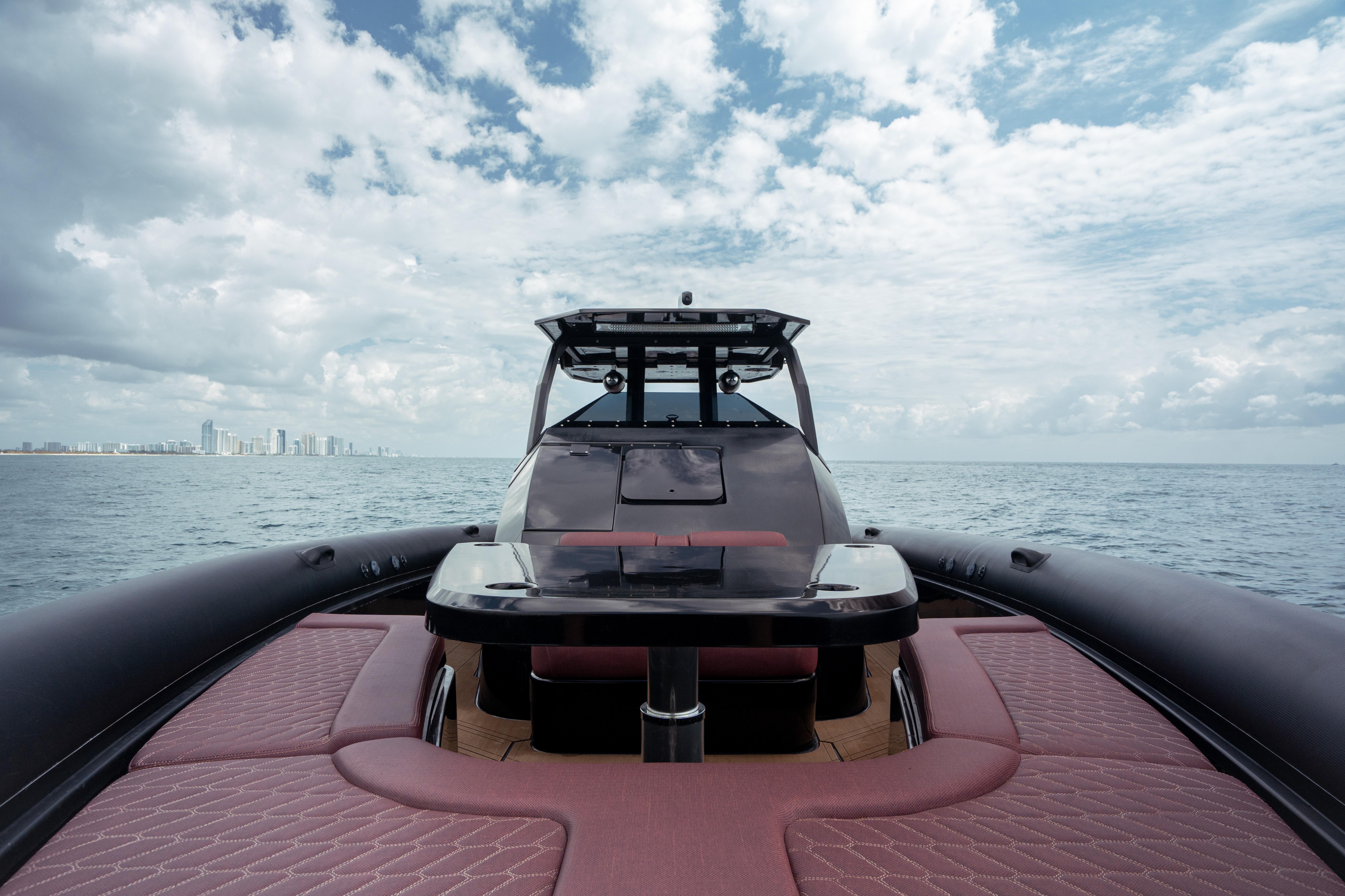 Skipper-BSK-42NC 2023 -FL-US-2023 Skipper-BSK 42NC luxury boat on open sea with city skyline.-9768987 | Thumbnail