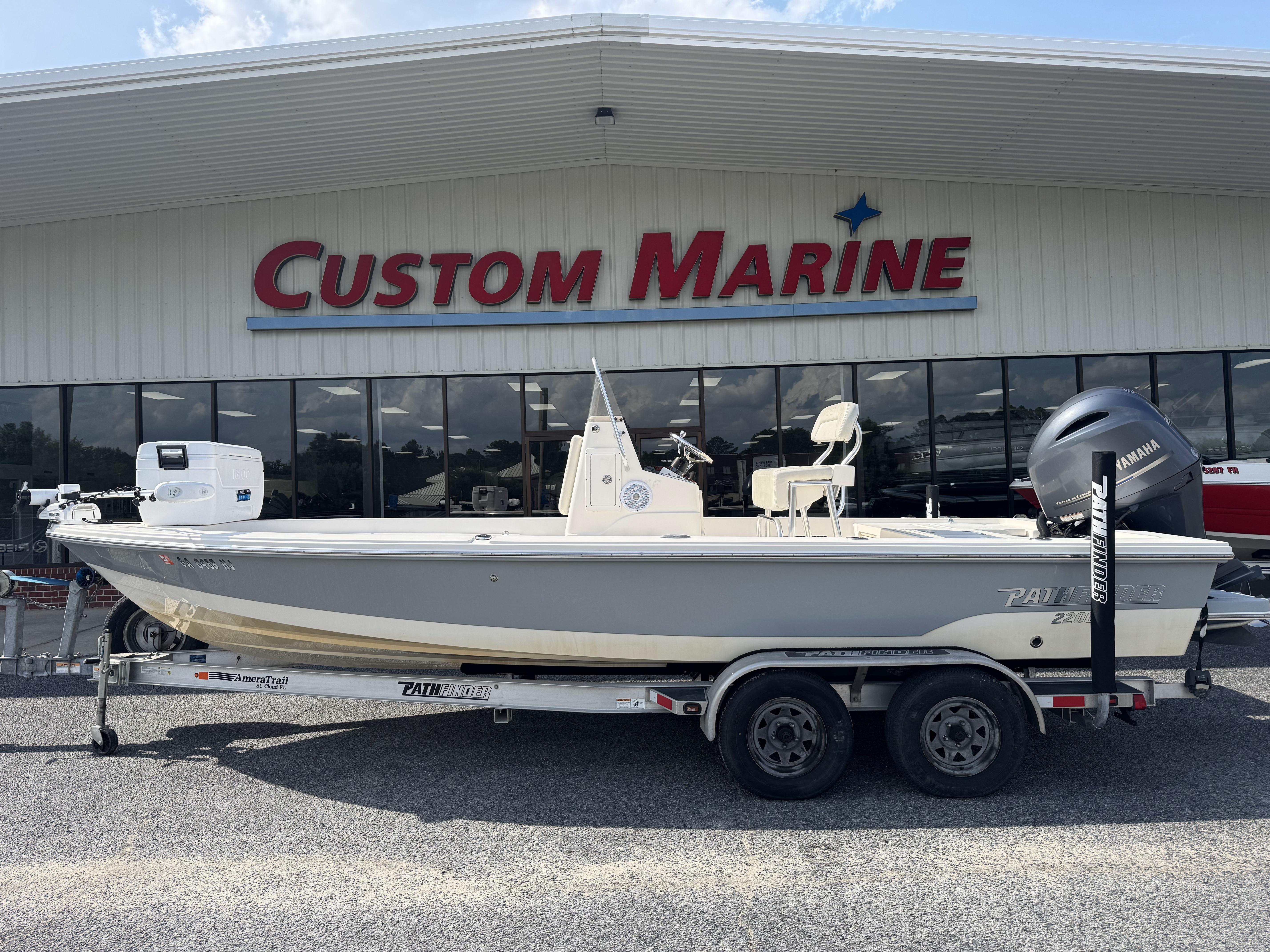 2014 Pathfinder 2200 TRS boat on trailer at Custom Marine dealership.