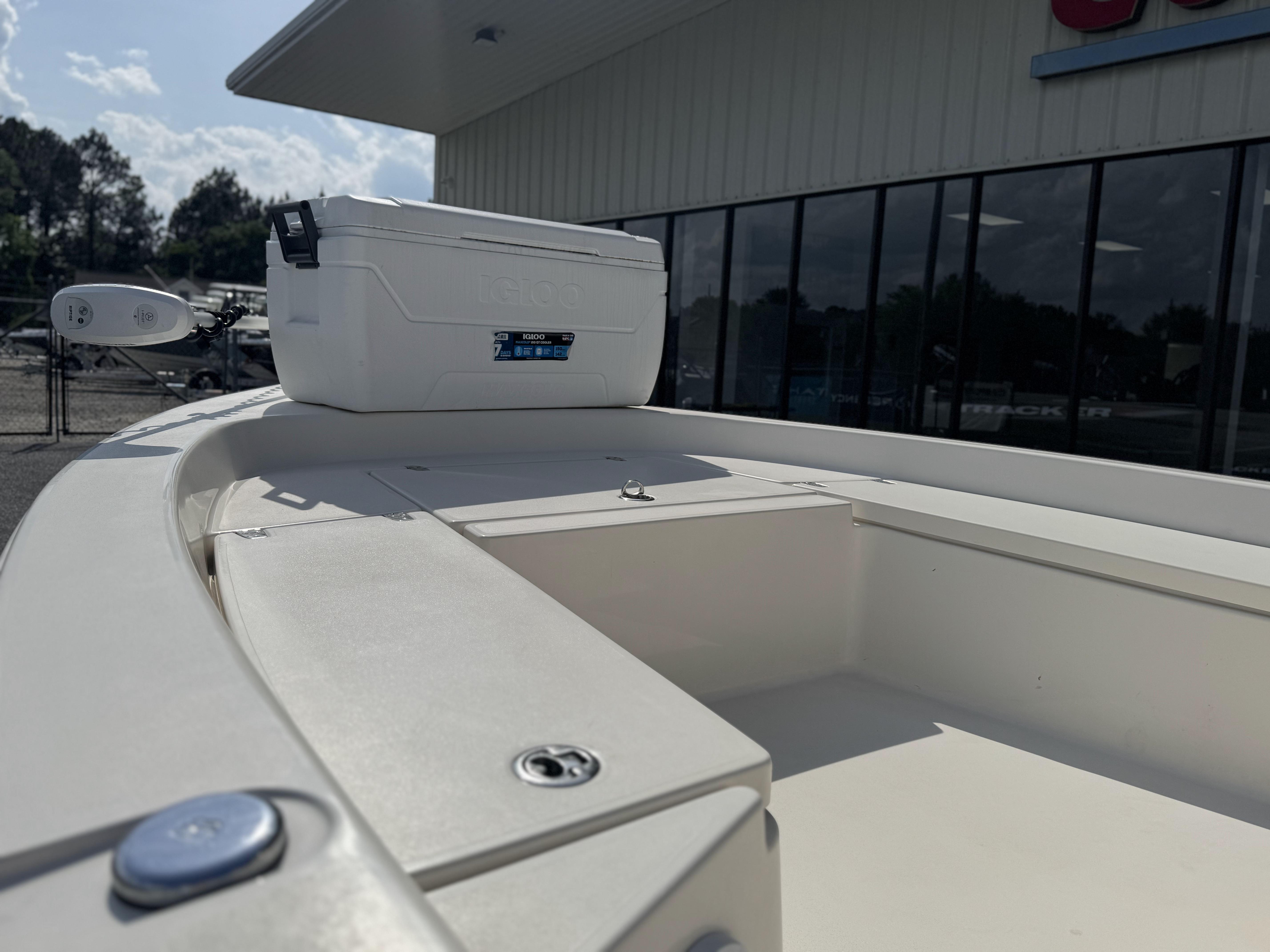 2014 Pathfinder 2200 TRS boat deck with cooler, parked outside a building.