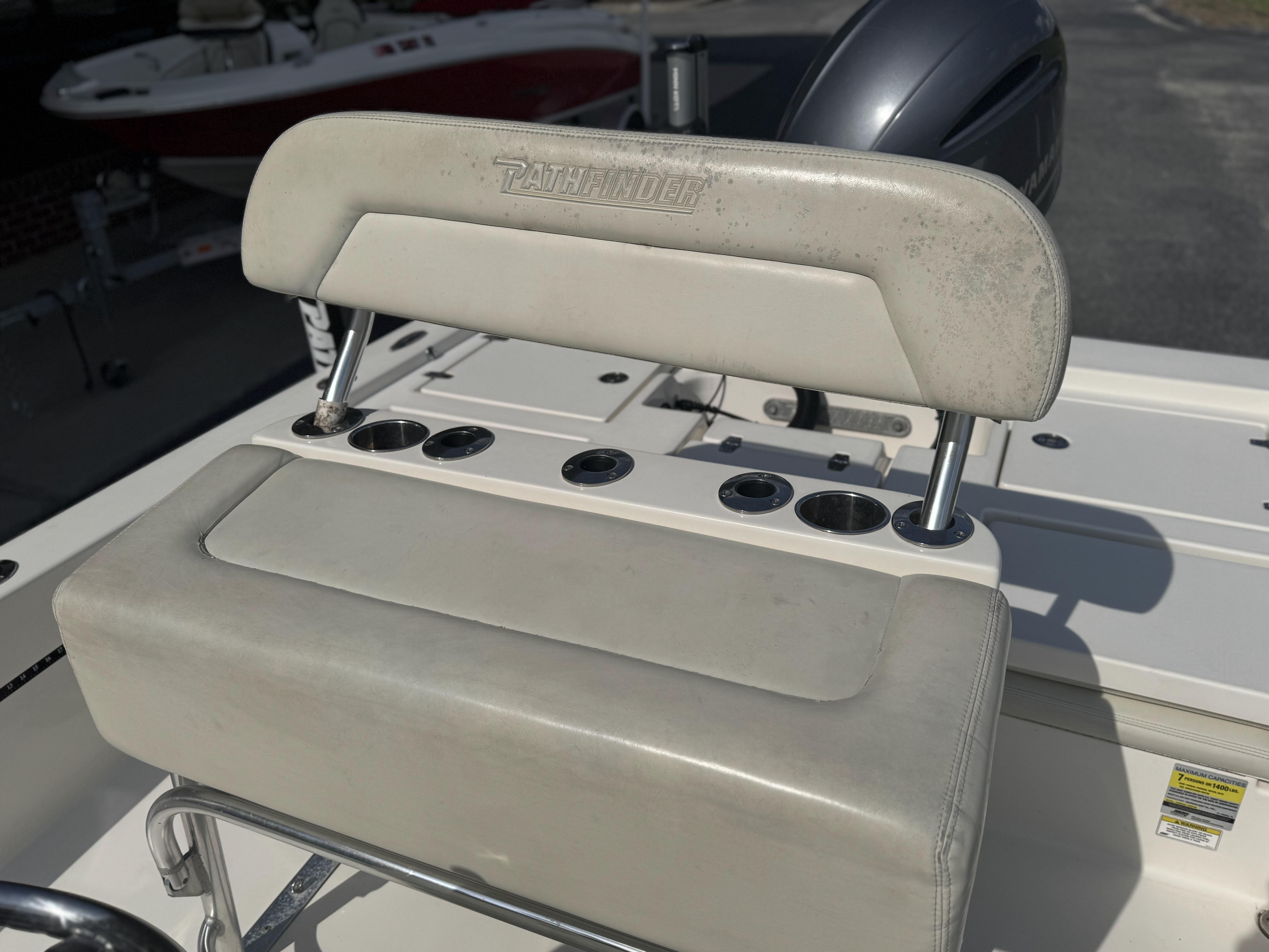 2014 Pathfinder 2200 TRS boat seat with rod holders and engine in background.