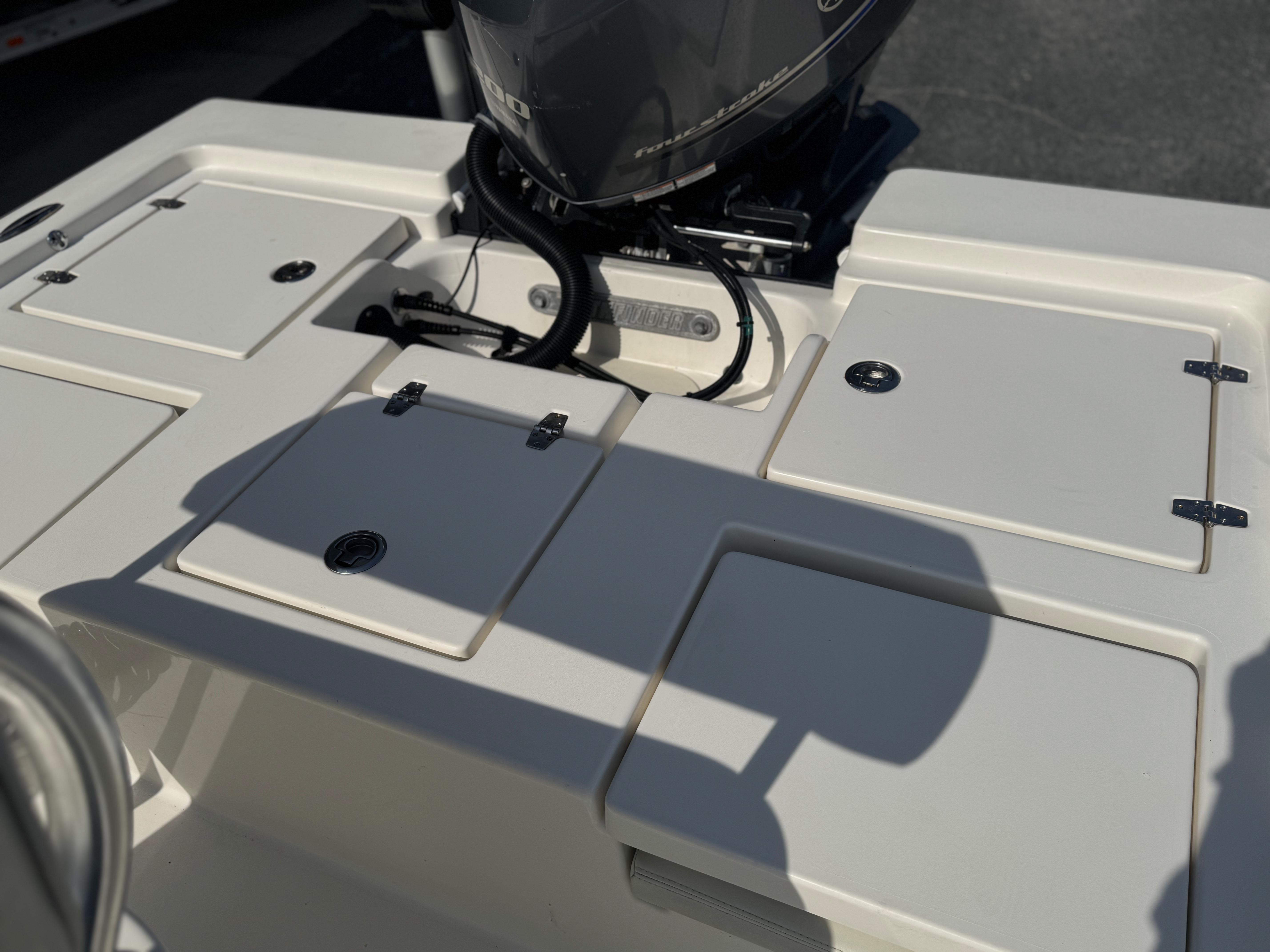 2014 Pathfinder 2200 TRS boat deck with storage compartments and engine.