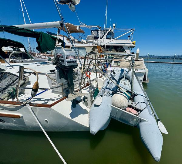 1996 Beneteau Oceanis 40 CC sailboat docked with inflatable dinghy attached.