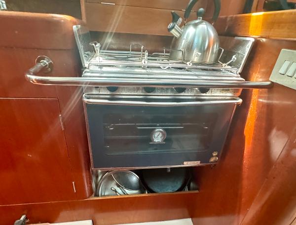 Galley stove and kettle in 1996 Beneteau Oceanis 40 CC yacht interior.